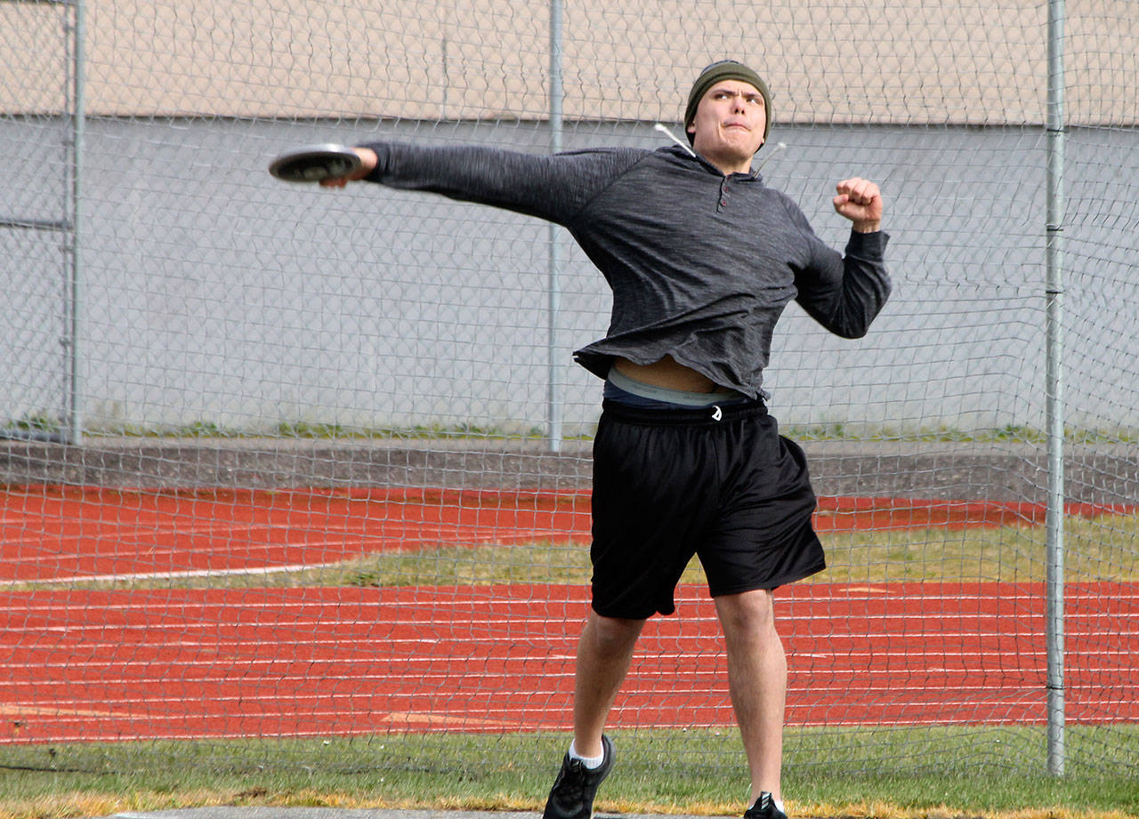 Dylan Davis tosses the discuss Saturday. (Photo by Jim Waller/South Whidbey Record)