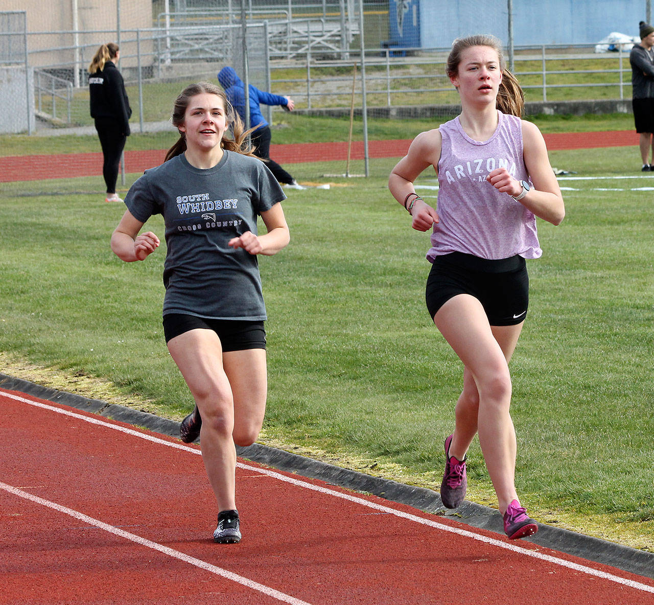 The 1,600 and 3,200 were run simultaneously Saturday. Grace Huffman, left, won the 1,600, and Kaia Swegler Richmond, right, captured the 3,200.(Photo by Jim Waller/South Whidbey Record)