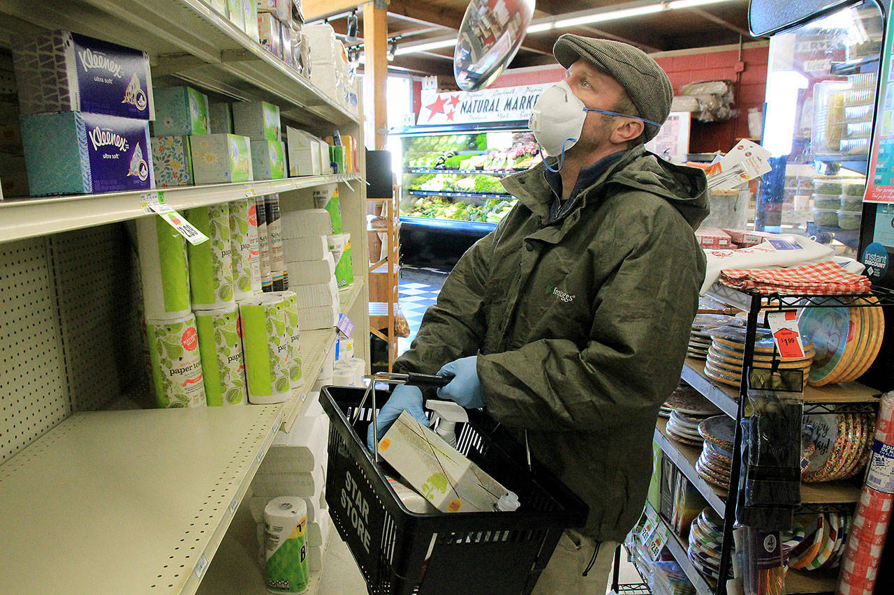 Photo by Kira Erickson/Whidbey News Group                                Clinton resident Jake Stewart selects a box of Kleenex from the Star Store as part of a delivery order.