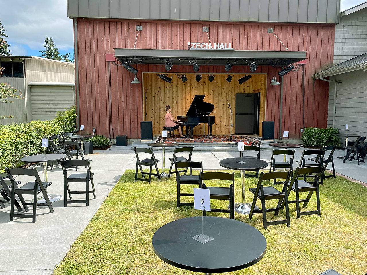 Photo provided                                Pianist Sheila Weidendorf practices a set on the newly renovated Zech Patio at Whidbey Island Center for the Arts in Langley. The venue has announced plans for summer performances. See page 9 for more on this story.