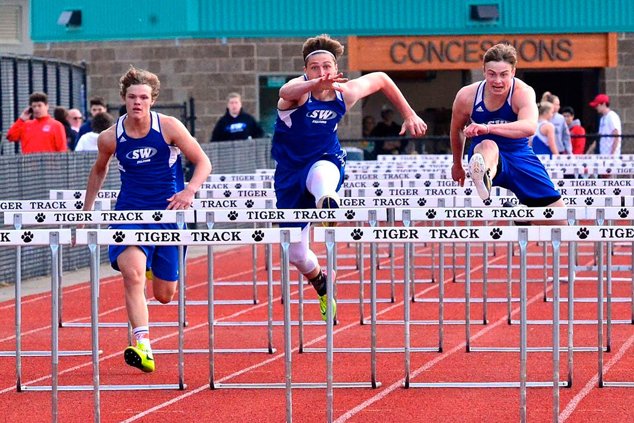 Cody Eager, left, Kole Nelson and Bodie Hezel run the 110 hurdles in the league meet in 2019. Hezel finished first, Nelson second and Eager fourth. (File photo)