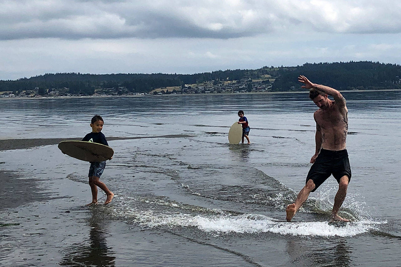 Auston Reisman skim boards at Double Bluff.                                Photo by Emily Gilbert/Whidbey News-Times.