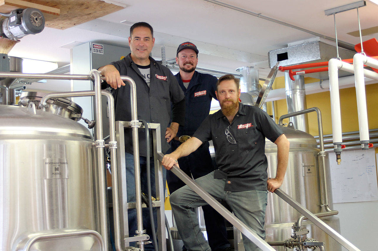 Photo by Jessie Stensland / Whidbey News-Times                                Marc Aparicio, Kyle Magnuson and Erickson Adam make up Penn Cove Brewing’s three-person brewing crew.