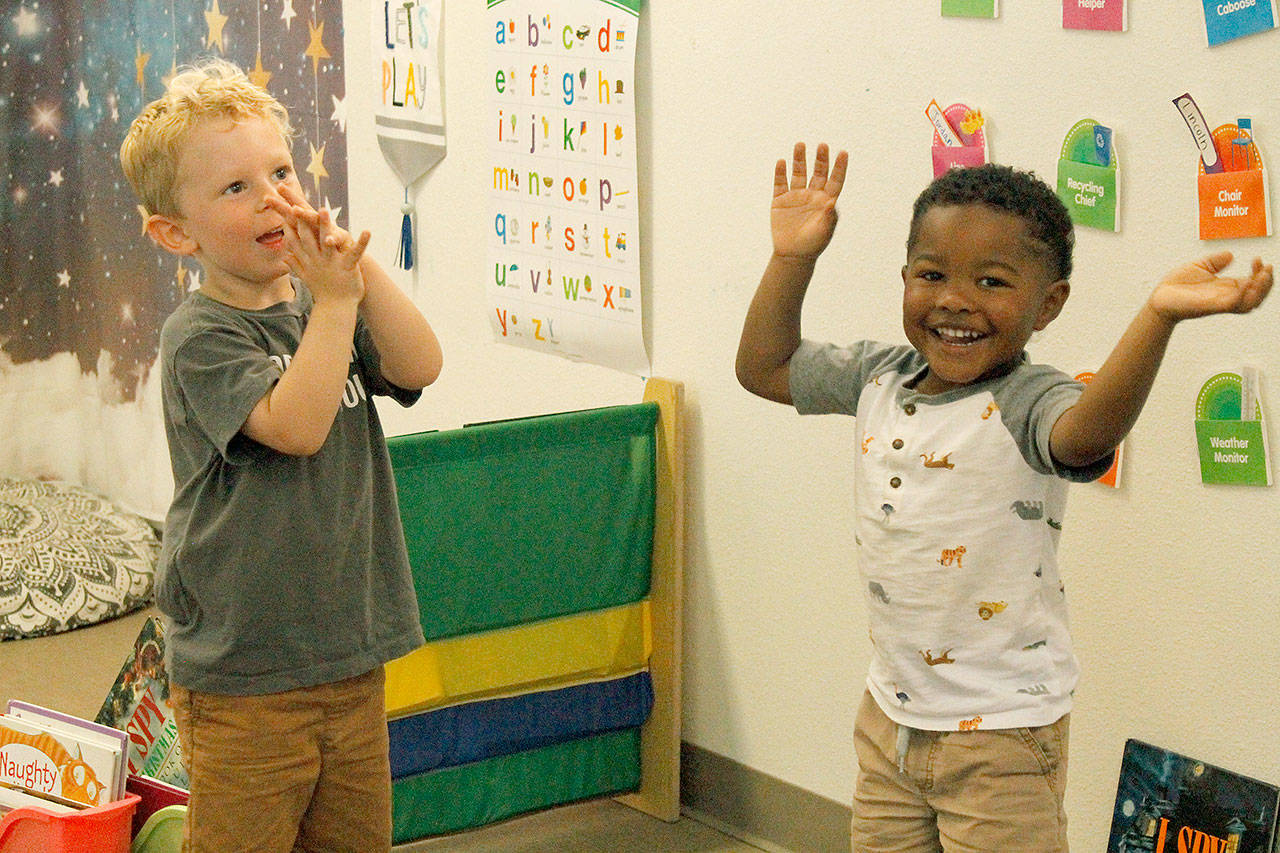 Lincoln Fresch, left, and Quintarius Eaves “clap the sillies out” during song time at Little Oaks Preschool & Childcare Center. Photo by Kira Erickson/Whidbey News Group.