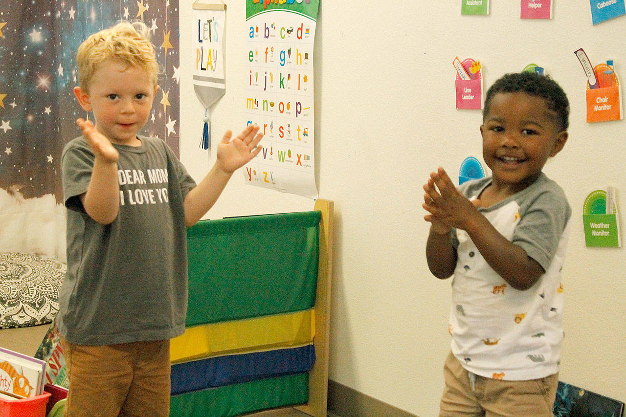 Lincoln Fresch, left, and Quintarius Eaves clap the sillies out during song time at Little Oaks Preschool & Childcare Center. Photo by Kira Erickson/Whidbey News Group.