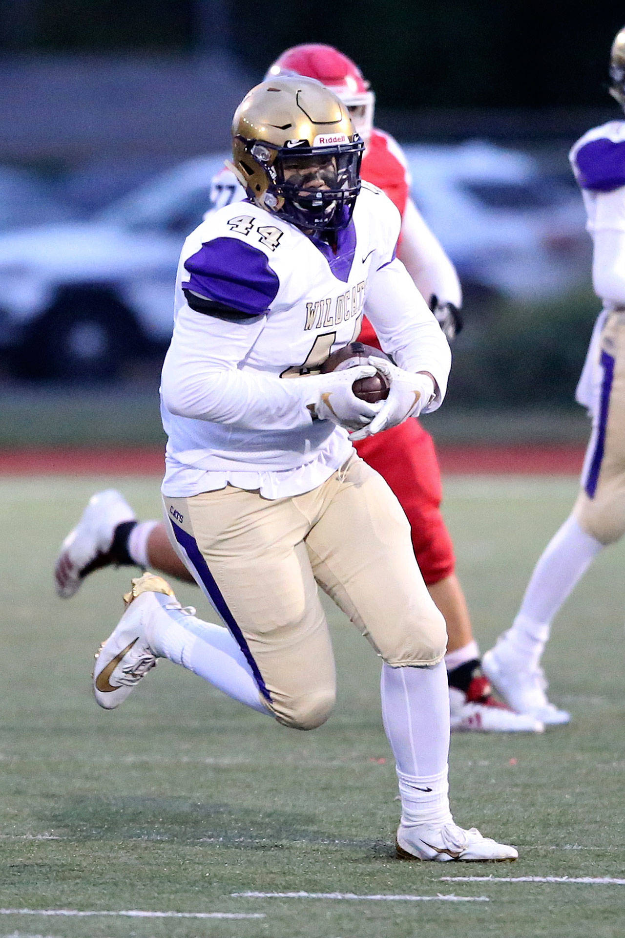 Oak Harbor tight end Nolan Byng advances the ball for the Wildcats last season. Byng and his teammates are adjusting to changes in high school football this school year. (Photo by John Fisken)