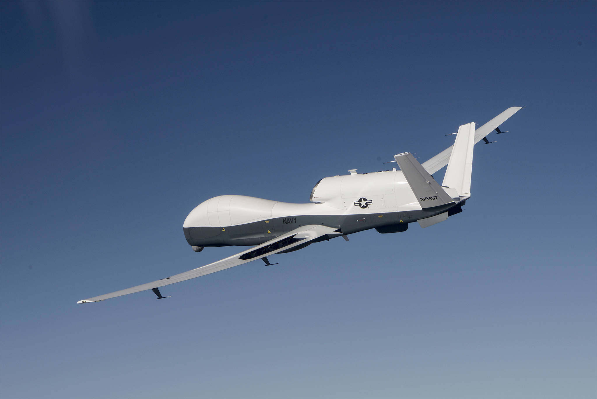 The MQ-4C Triton unmanned aircraft system flies over Edwards Air Force Base, Calif., during a flight test activity in June. Though the Northrop Grumman aircraft wont be landing at Naval Air Station Whidbey Island, Capt. Matt Arny said its mission will be run from the base. Photo by Alan Radecki.