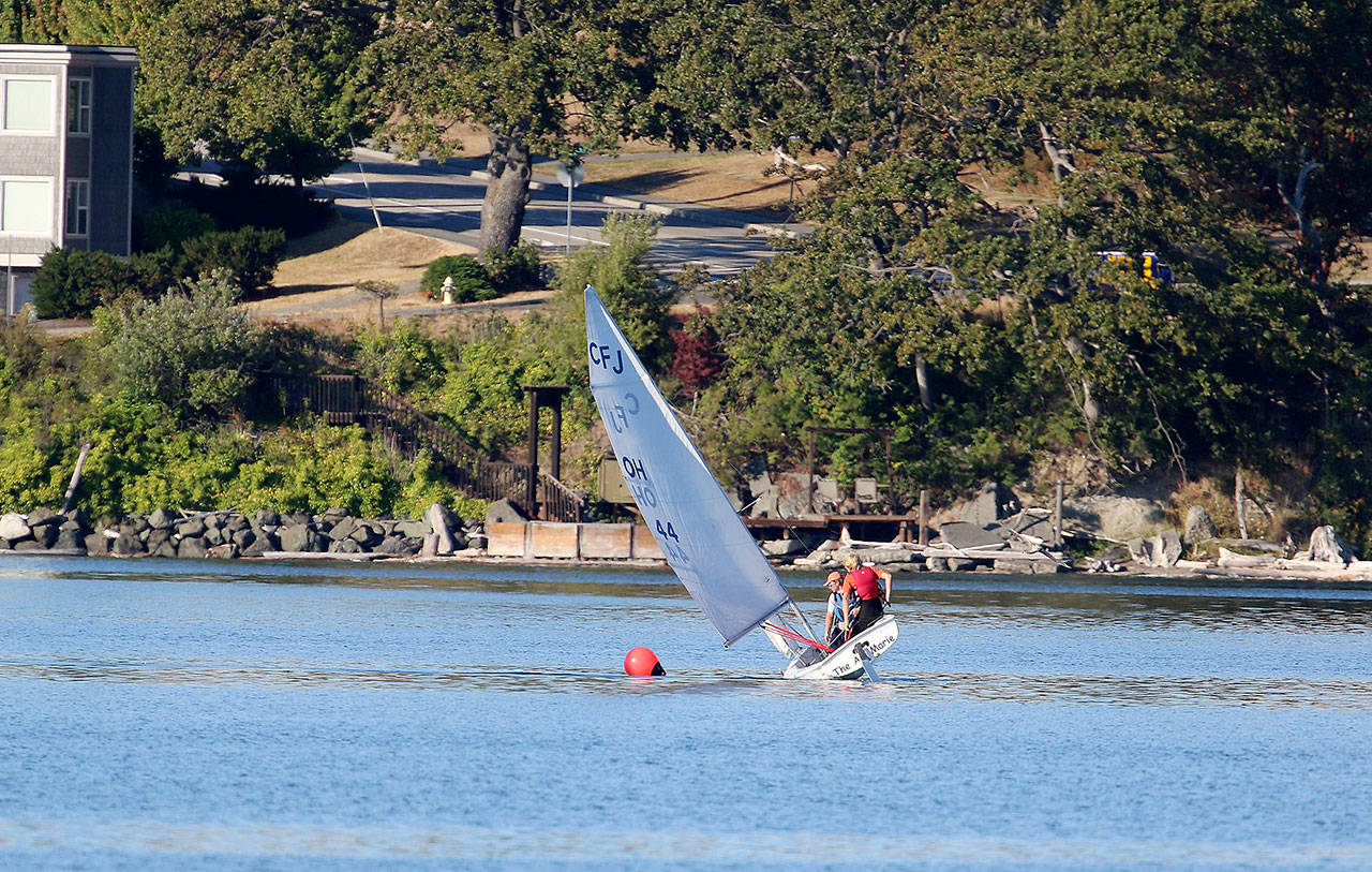 Brothers Thomas and Andrew Buys navigate around a buoy during practice last month. (Photo by John Fisken)