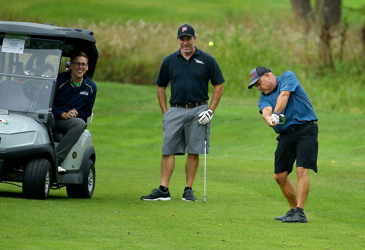 Mitch Aparicio, one of the owners of the Penn Cove Brewing Company, chips to the green. (Photo by John Fisken)