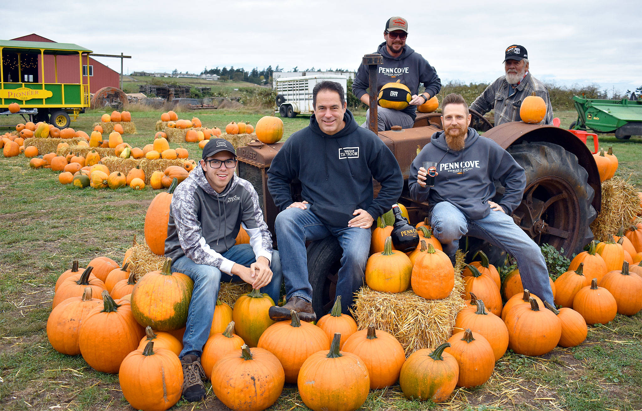 The Penn Cove Brewing Co. team, Andrew Aparicio, Marc Aparicio, Kyle Magnuson and Erickson Adam, with their new pumpkin stout’s namesake, farmer Dale Sherman (far right), go back to the roots of their new tasty brew. Photo by Emily Gilbert/Whidbey News-Times