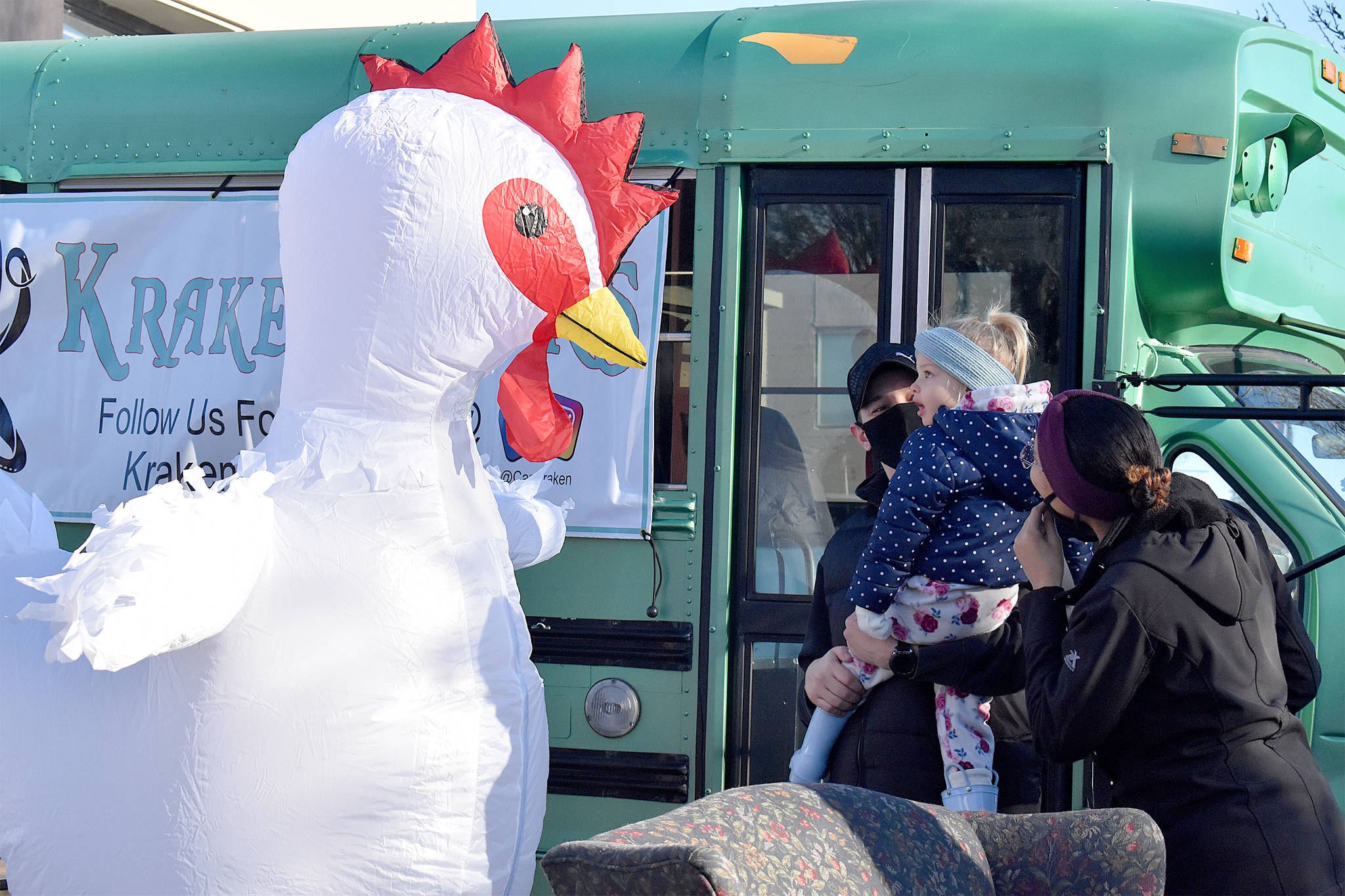 The Whidbey Island Chicken meets young fan, Aria Smith, and her dad, Josiah, on Saturday morning in Oak Harbor. Emily Gilbert/Whidbey News-Times