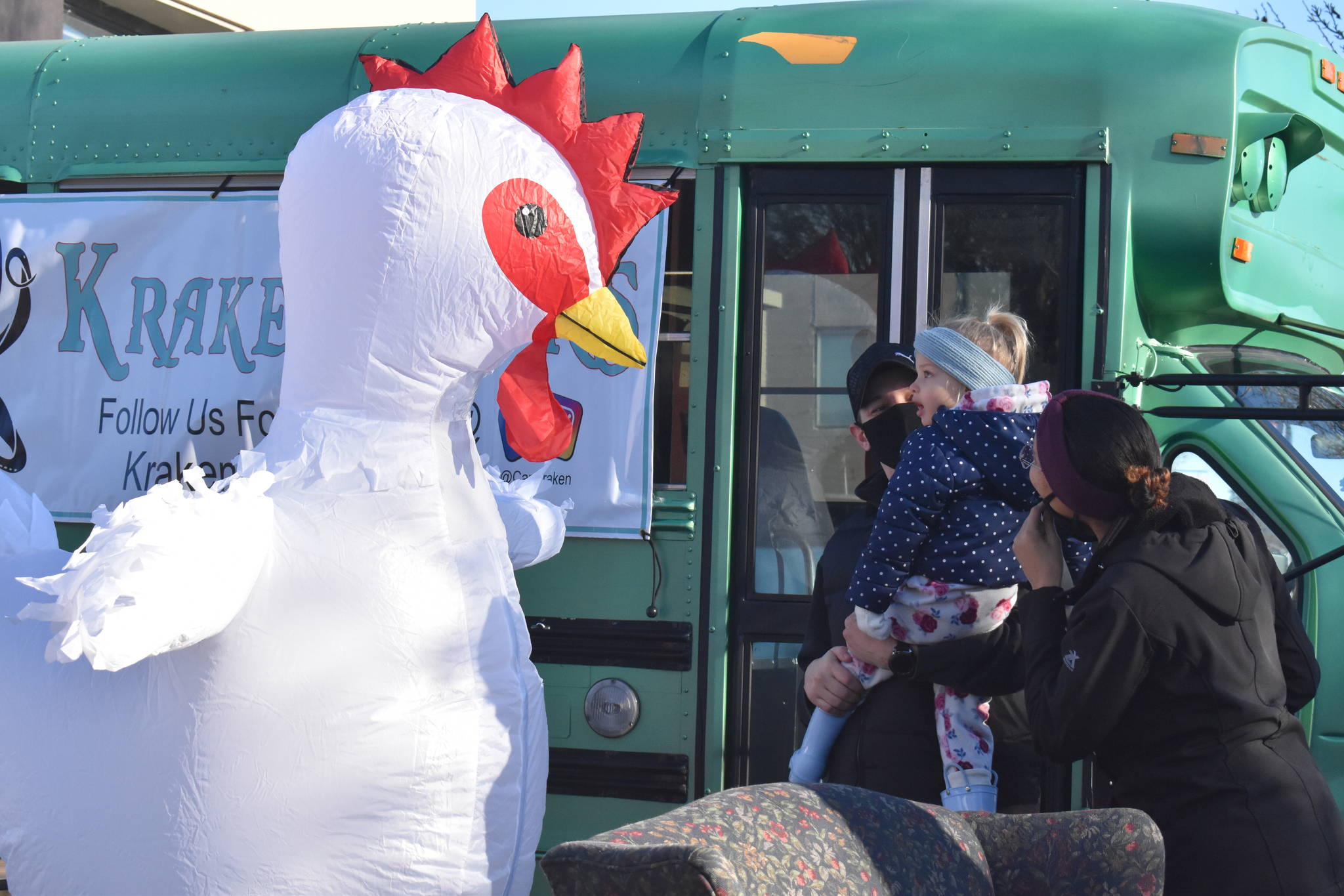 The Whidbey Island Chicken meets young fan, Aria Smith, and her dad, Josiah, on Saturday morning in Oak Harbor. Emily Gilbert/Whidbey News-Times