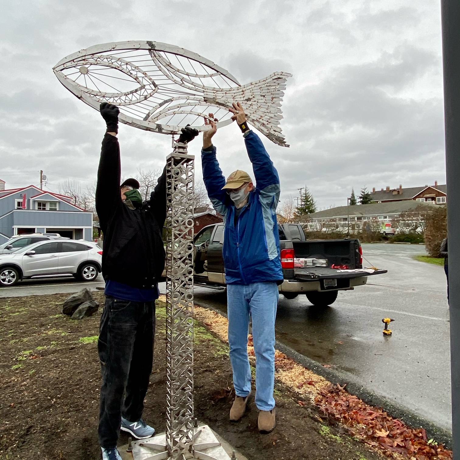 Artist Wayne Kangas, left, and Langley Arts Fund member Don Wodjenski install the Village by the Sea’s newest public art feature, a weather vane. Photo provided