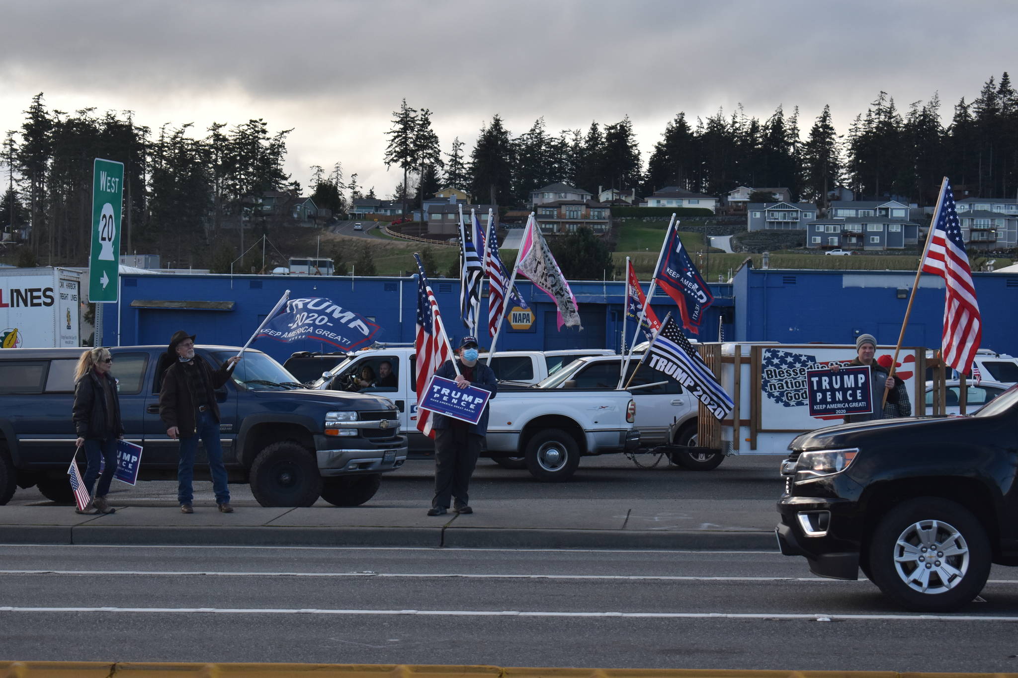 On Wednesday, Trump supporters gather at the intersection of Highway 20 and Southeast Pioneer Way in Oak Harbor to show their support for the outgoing president, and to protest the election of Joe Biden The event coincided with the storming of the U.S. Capitol by other President Donald Trump supporters. Photo by Emily Gilbert/Whidbey News-Times