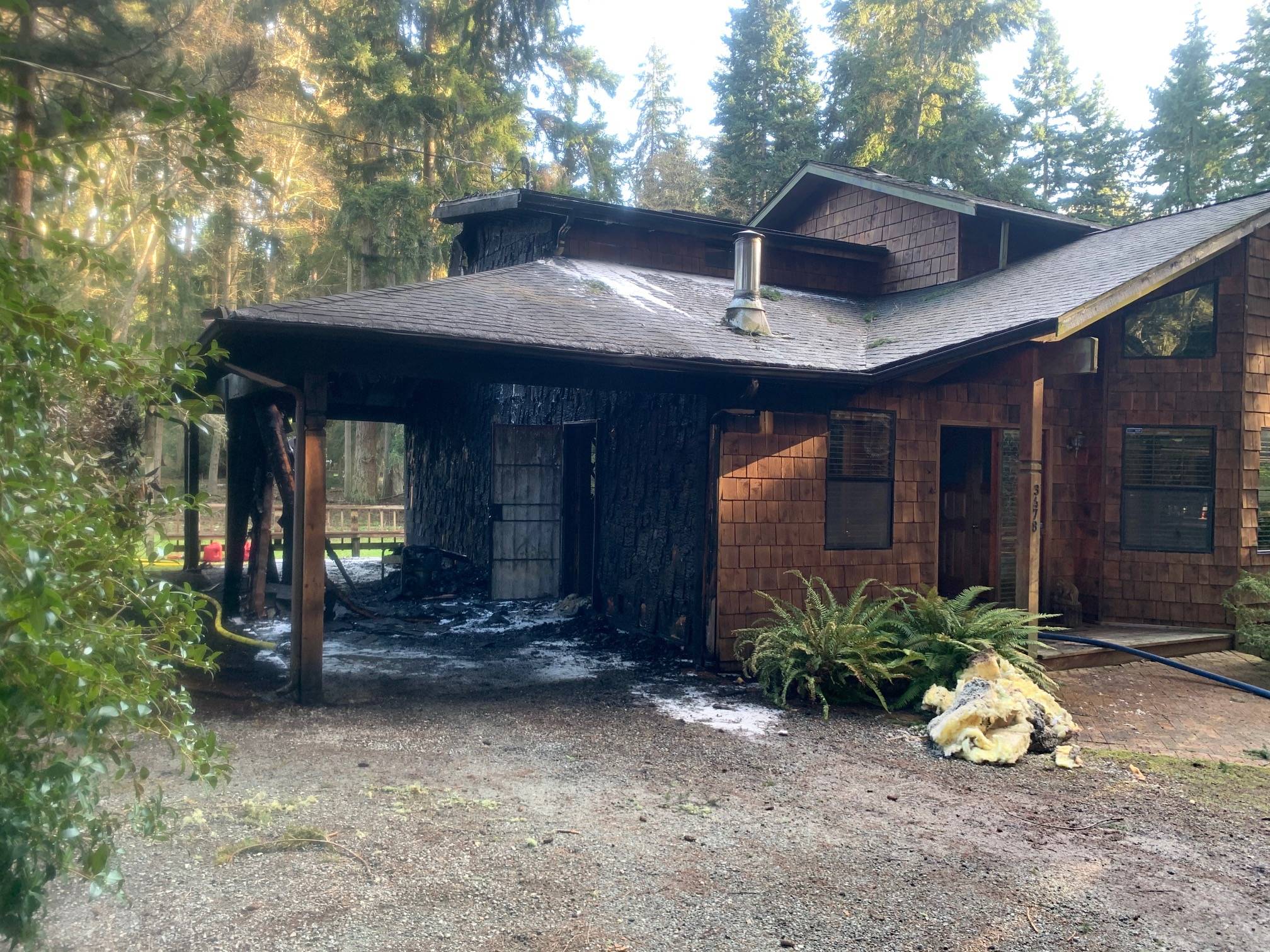 An Owl Haven Lane home on South Whidbey was damaged by a fire Wednesday morning, although the homeowner was able to save many of his possessions. Photo provided by South Whidbey Fire/EMS