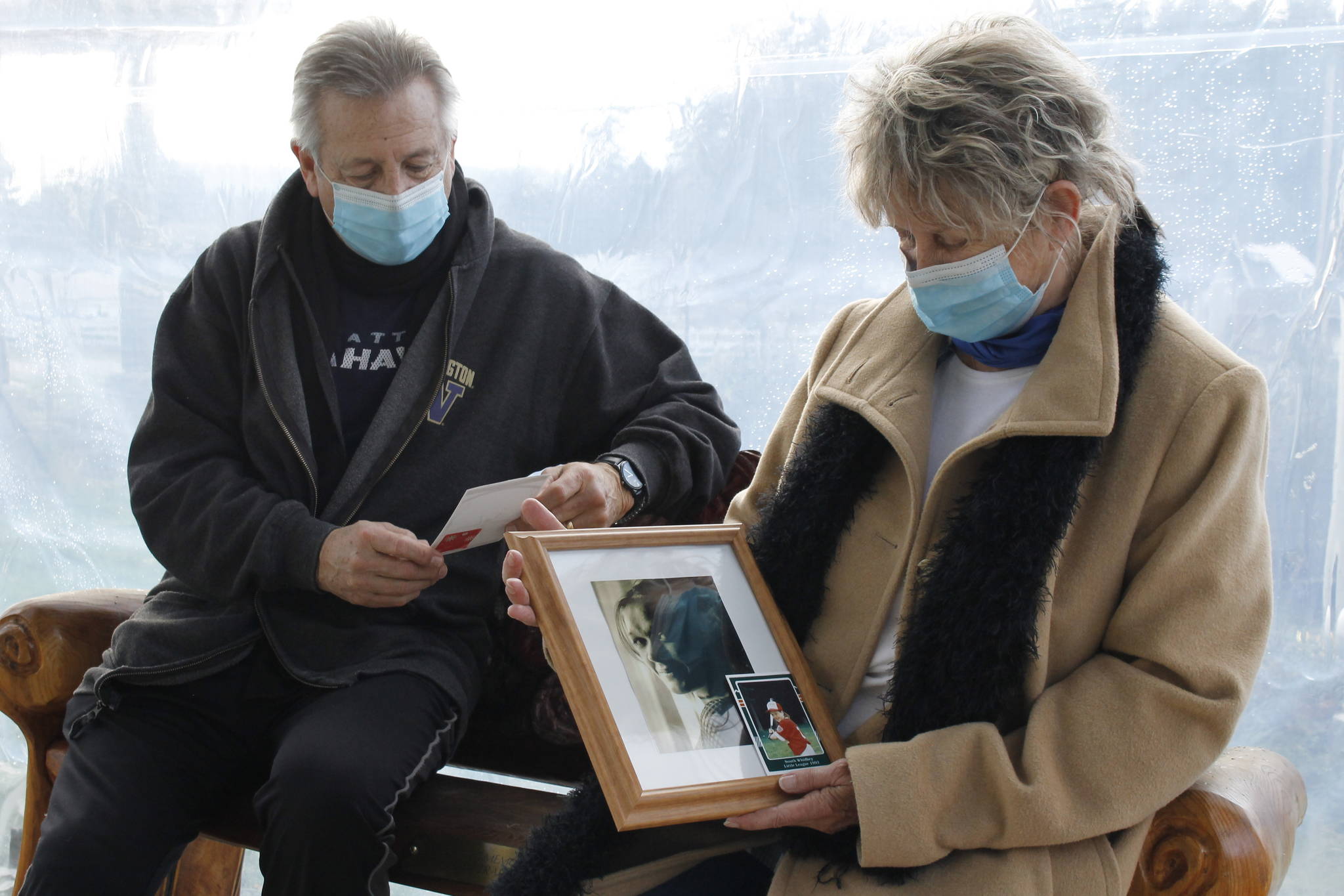 Paulette and Greg Beck reflect on photos of their daughter, Piper Travis, who died in 2017. Photo by Kira Erickson/South Whidbey Record