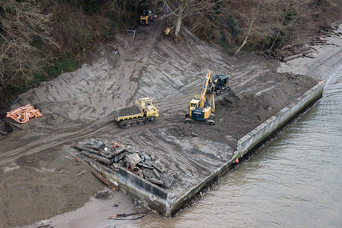 Dirt is moved during the deconstruction of a seawall on Friday, Jan. 29, 2020 in Langley, Wa. Shoreline restoration underway north of Langley involves removal of an old barge and bulkheads. Sea level rise makes such habitat improvements all the more important to endangered salmon and their prey. The project is a partnership between Seahorse Siesta property owners and the Northwest Straits Foundation. (Olivia Vanni / The Herald)