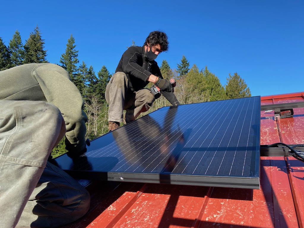 Adam Wundrow of Whidbey Sun and Wind installs a solar panel.