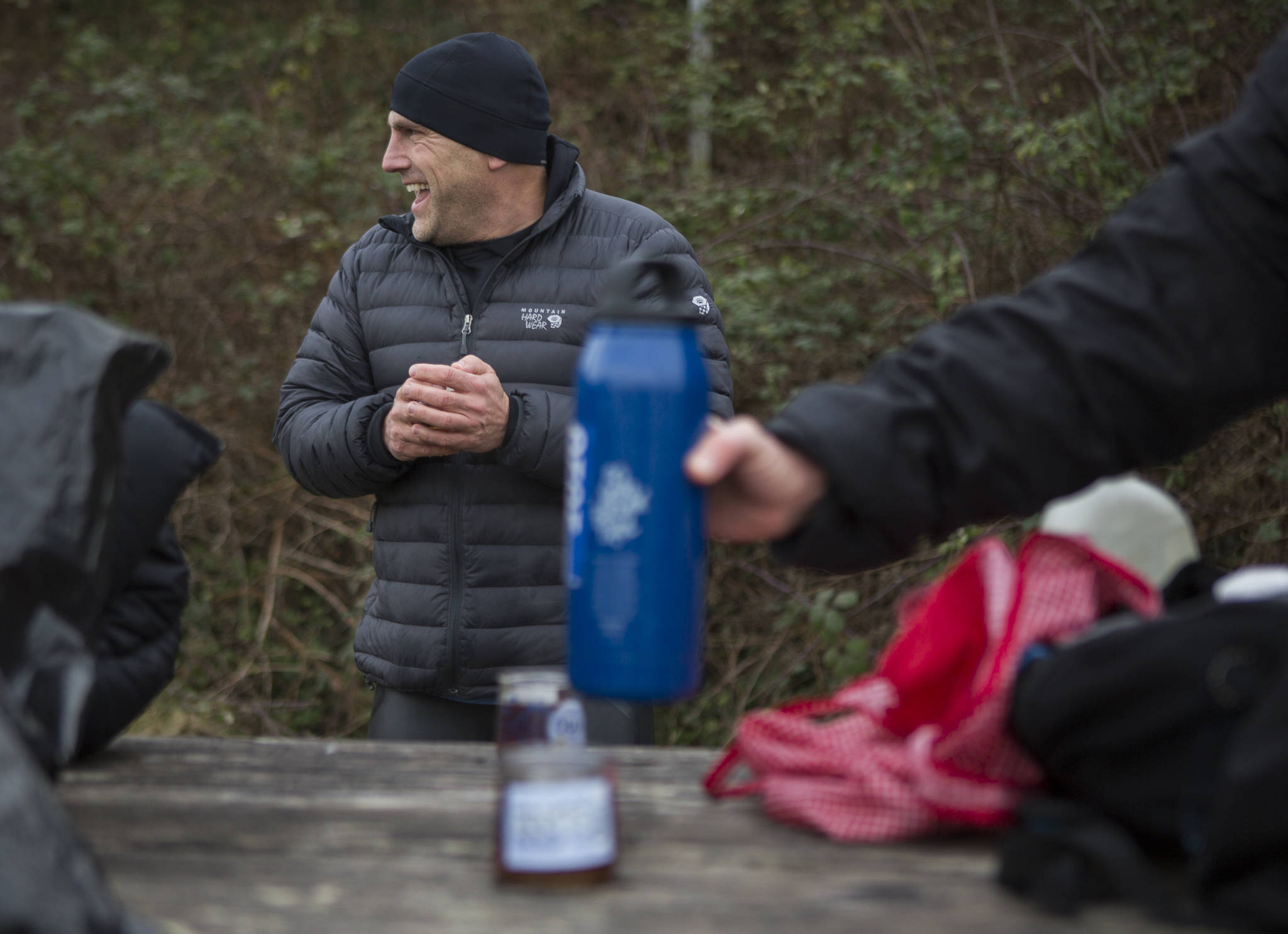 Joe Hempel laughs as passersby ask about what they are doing Jan. 29 while hot tea is passed around in Langley. (Olivia Vanni / The Herald)