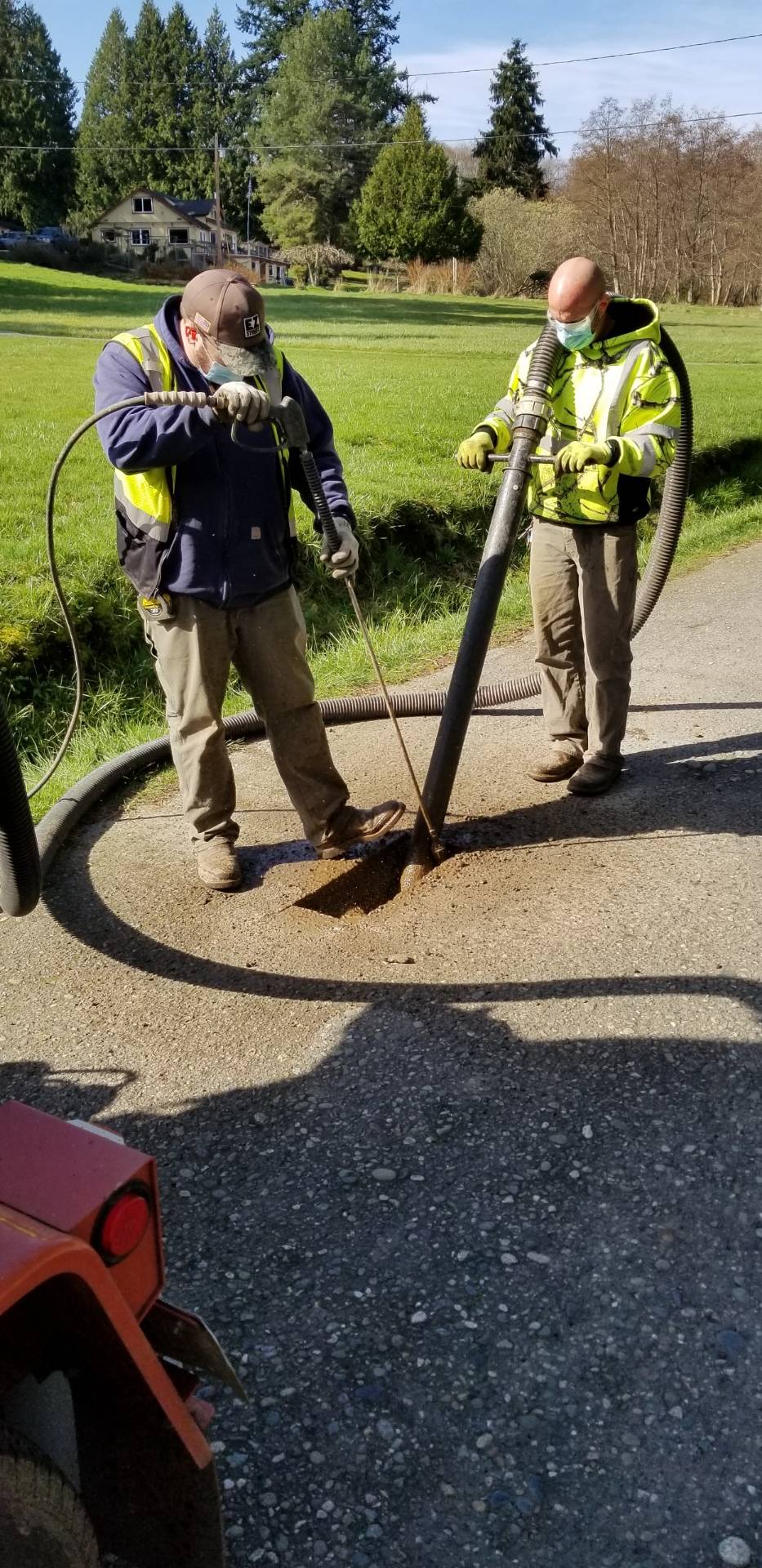 Photo provided by Randi Perry
Tim Grove, left, and Byron Hamilton work on potholing the Langley streets Thursday morning.
