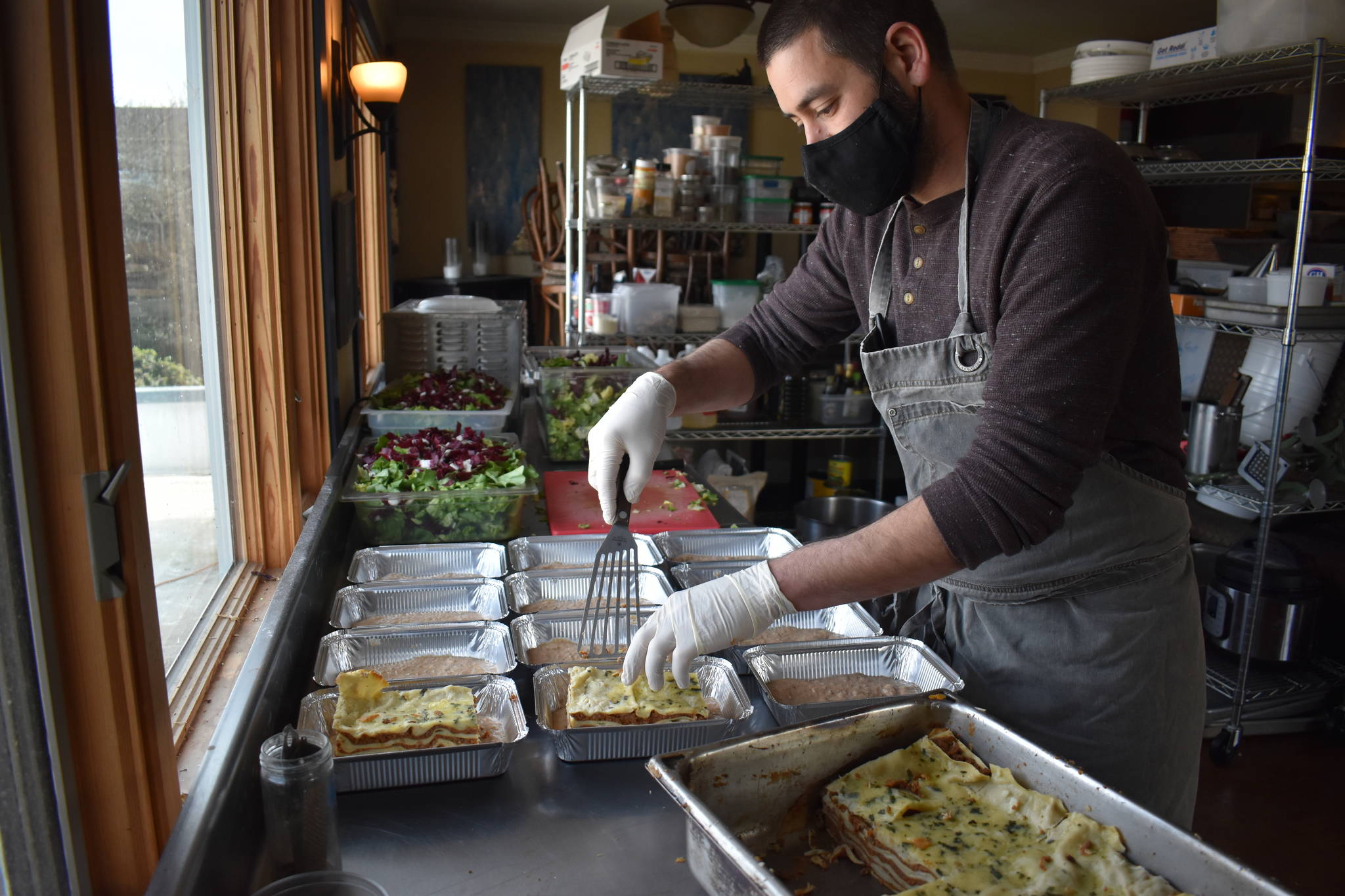 The Oystercatcher’s owner and chef, Tyler Hansen, prepares a dozen 3 Sisters beef bolognese lasagnas to go on the shelves at 3 Sisters Market. Photo by Emily Gilbert/Whidbey News-Times