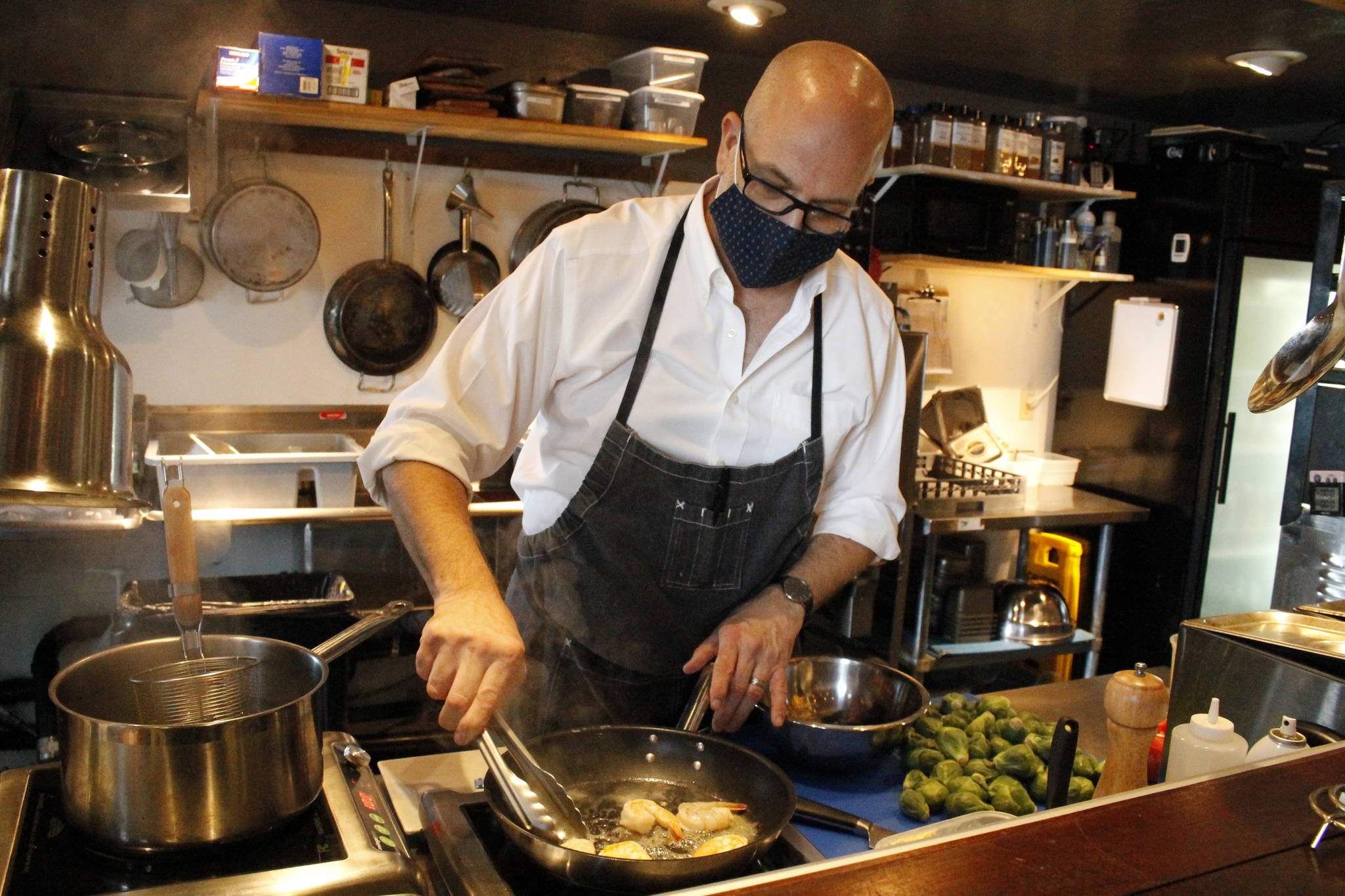 Stefen Bosworth, co-owner and chef of Savory, cooks up some squid ink linguine. (Photo by Kira Erickson/South Whidbey Record)