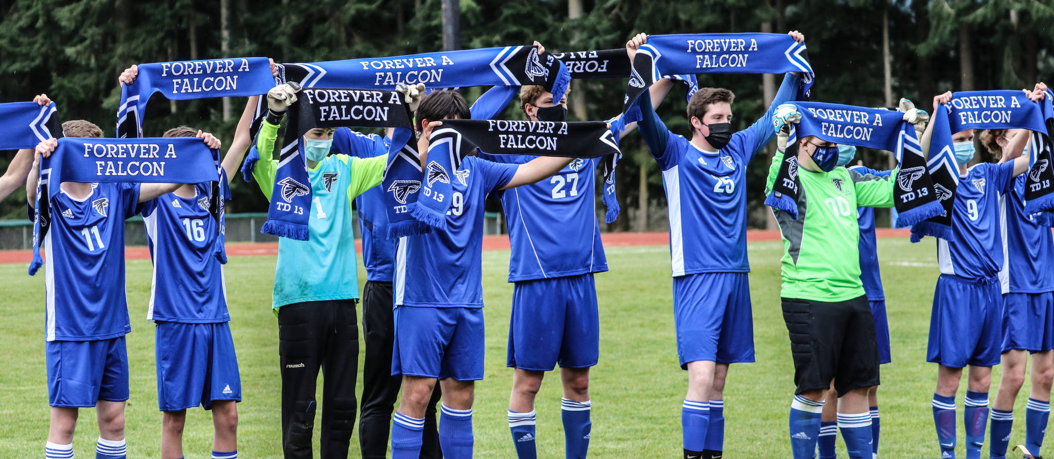 Photo by Matt Simms
‘Scarves Up’ soccer tradition that in this case was done in honor of fallen teammate and friend Taylor Daniels. The scarves were specially made in tribute to Taylor and are inscribed with his name and jersey number and the saying ‘Forever a Falcon’. They were given to Taylor’s mother by Coach Fuss and to the rest of Taylor’s extended family by the players who then raised them over their heads in the ‘Scarves Up’ pregame tradition for a moment of silence to honor Taylor’s memory.