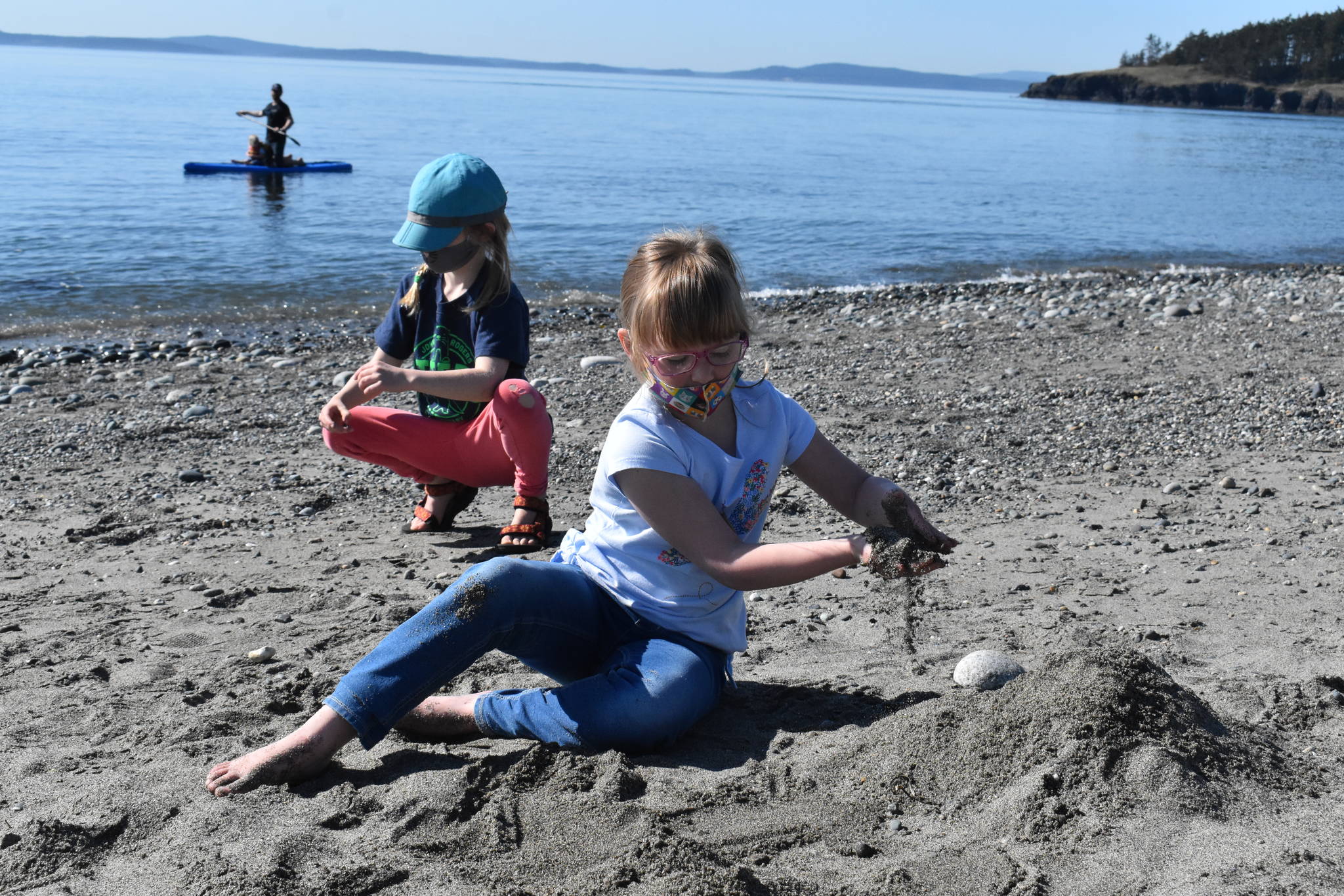 Six-year-olds Tilly Gignoux, left, and Kaylee Martin, right, construct a chair from sand at West Beach in Deception Pass State Park on Thursday afternoon.
(Photo by Emily Gilbert/Whidbey News-Times)
