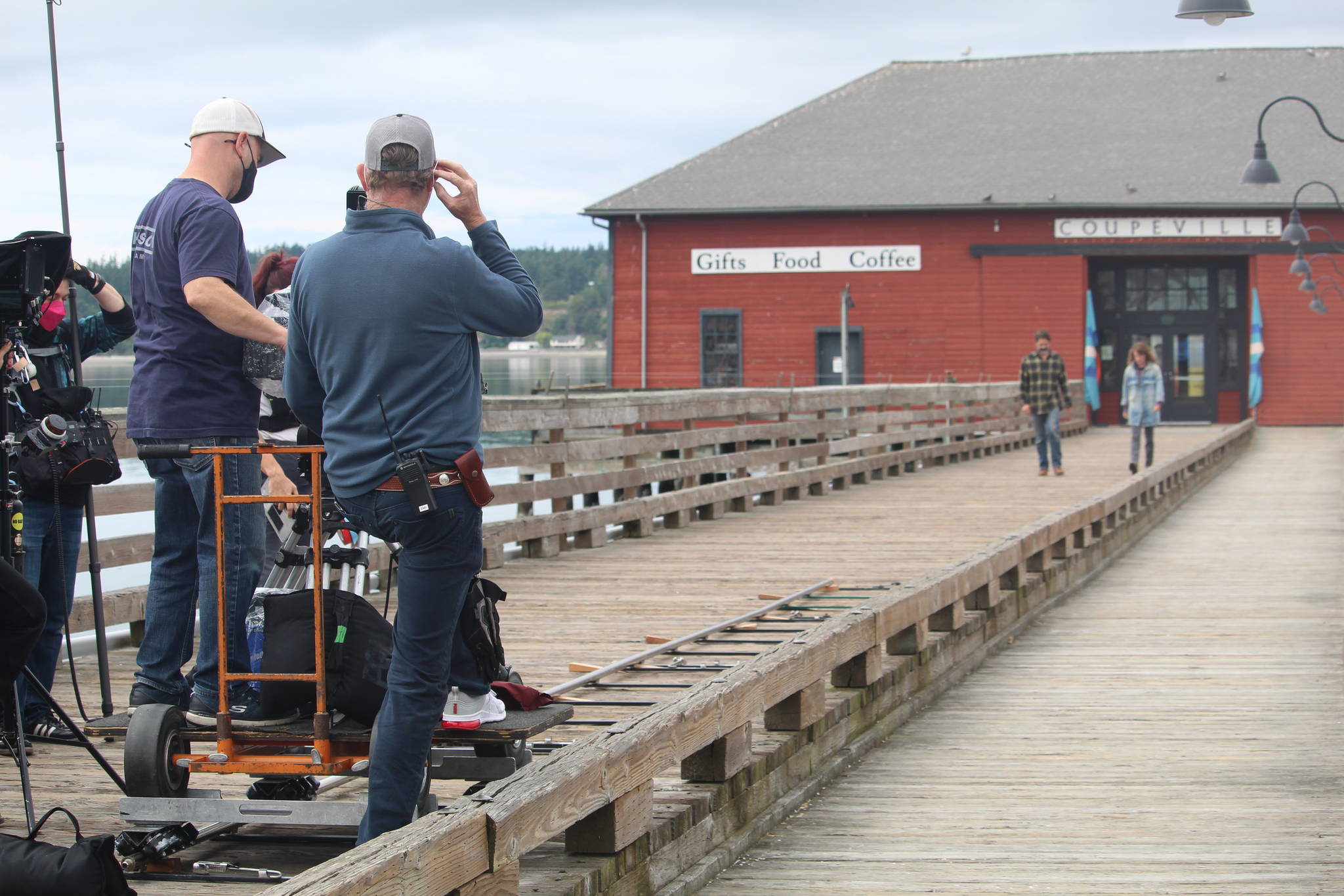 Chris Stack and Samantha Soule film a scene of their movie, Midday Black, Midnight Blue, on the Coupeville wharf June 14. (Photo by Karina Andrew/Whidbey News-Times)
