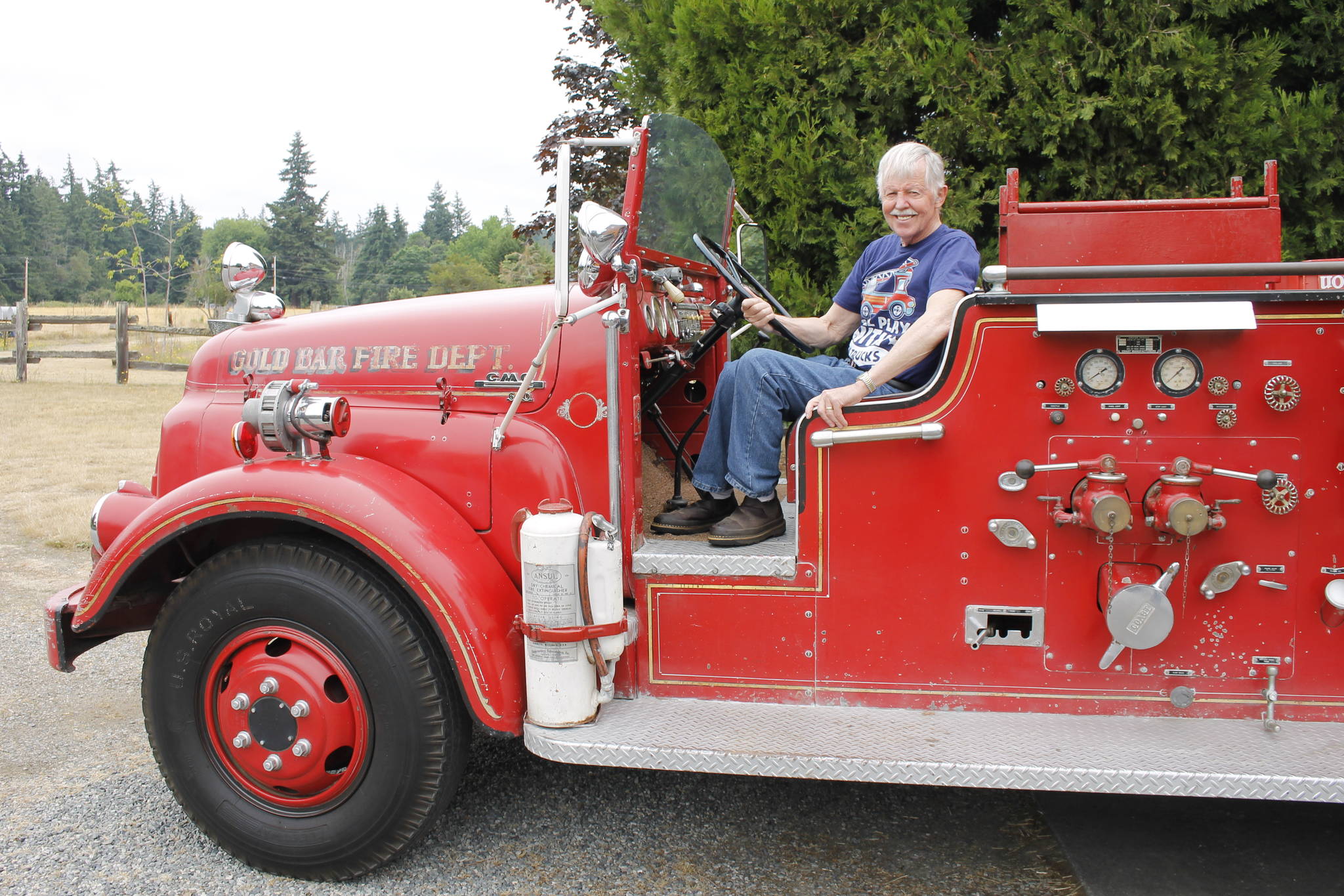 Gary Gabelein, this year’s grand marshal of the Whidbey Island Fair parade, sits atop his 1951 fire engine. (Photo by Kira Erickson/Whidbey News-Times)