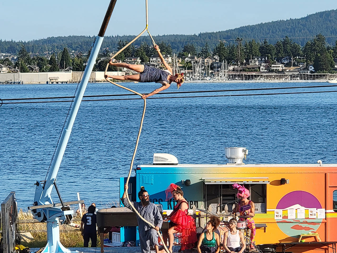 Up Up Up Inc., a traveling circus on a flatbed truck stage with a crane for aerial acts, performs Wednesday in Langley and Friday in Everett on its monthlong Pacific Northwest tour. It’s seen here at a show on Guemes Island north of Anacortes. (Submitted photo)