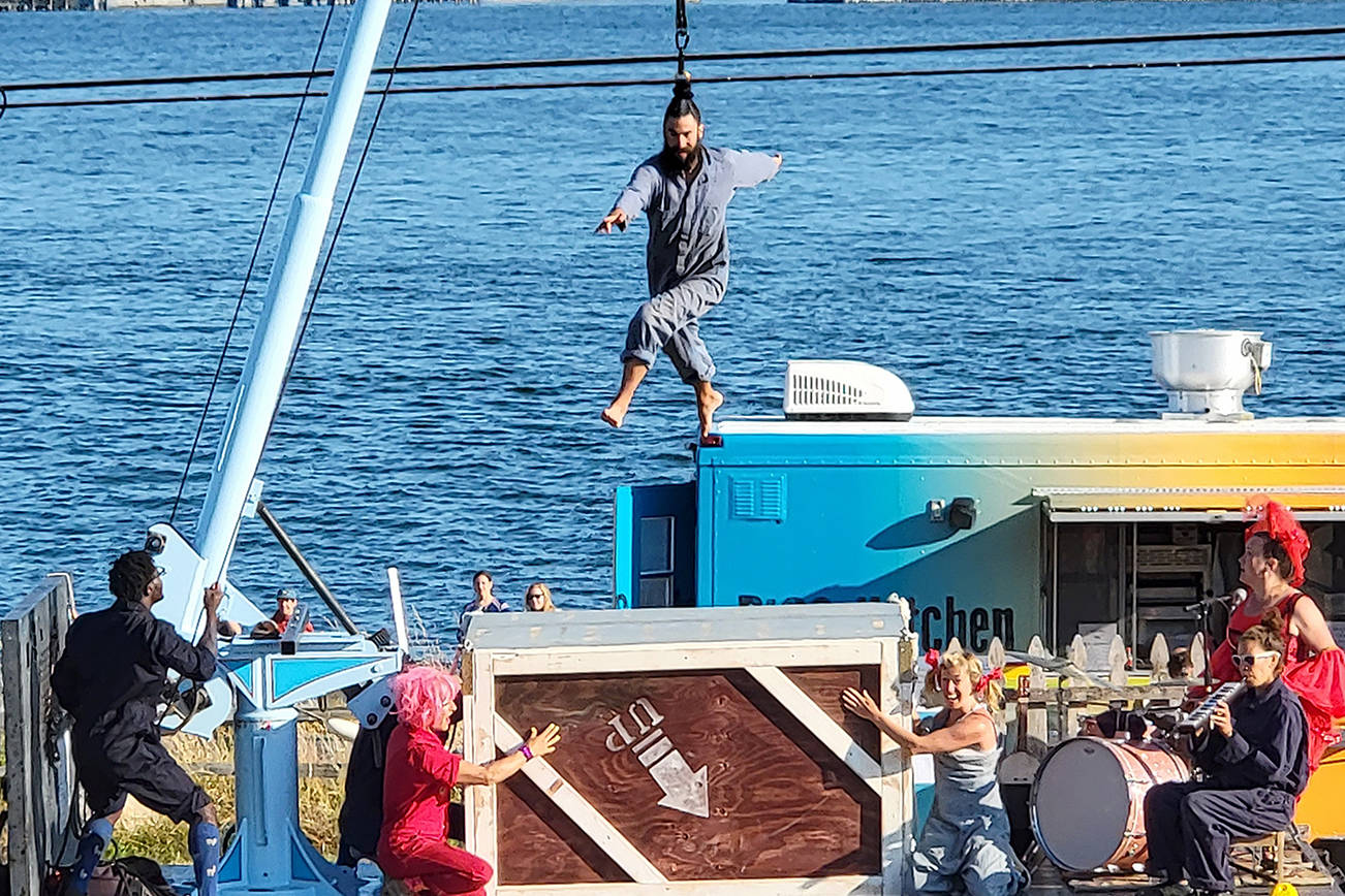 Up Up Up Inc., a traveling circus on a flatbed truck stage with a crane, performs Wednesday in Langley and Friday in Everett on its monthlong Pacific Northwest tour. Seen here at a show on Guemes Island. (Submitted photo)