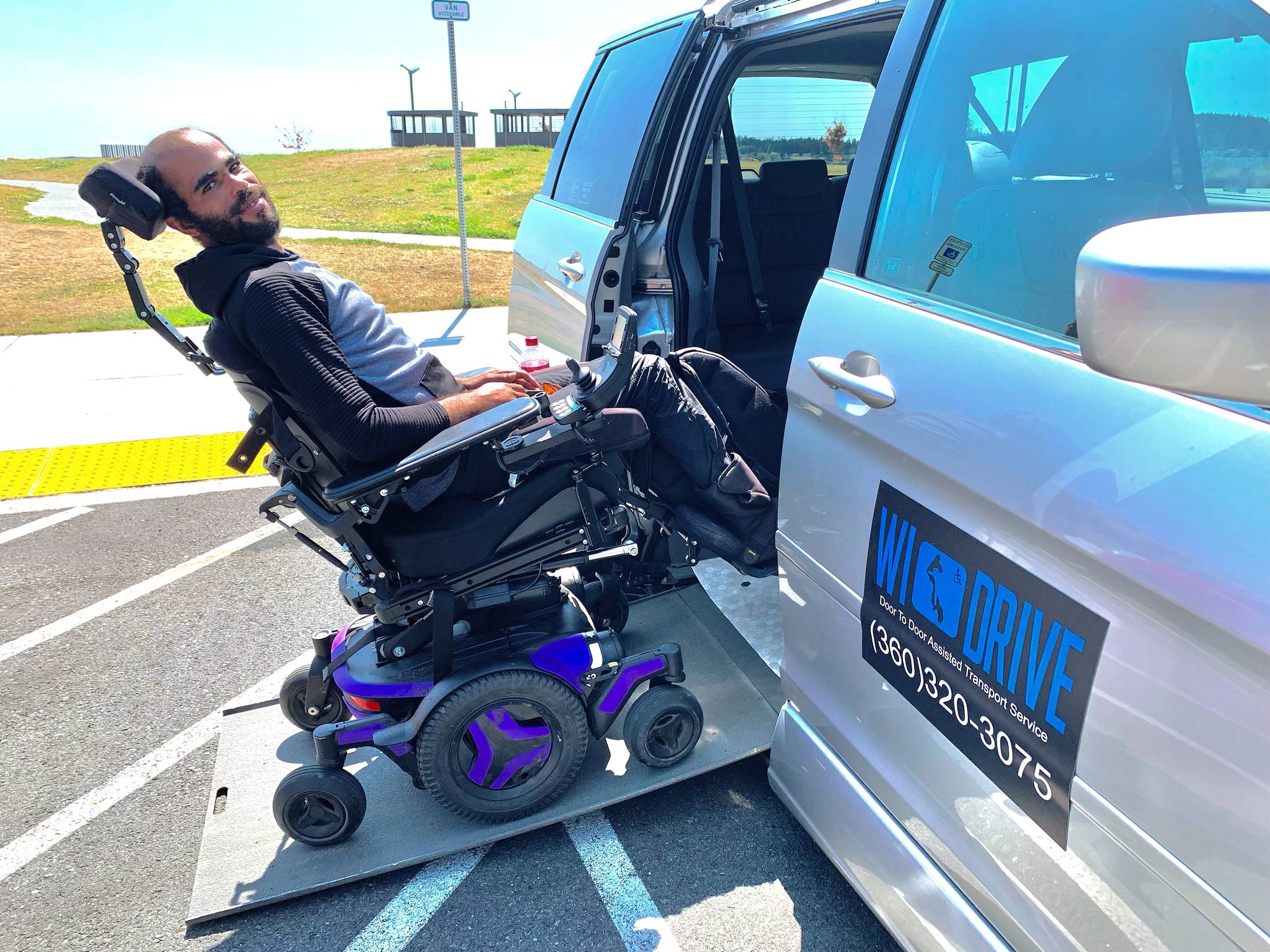 Photo by Heather Mayhugh
Stuart Peeples demonstrates how to enter Heather Mayhugh's wheelchair van. In recent months, while navigating the new Mukilteo ferry terminal, Mayhugh has struggled to unload her clients who need access to the restroom.