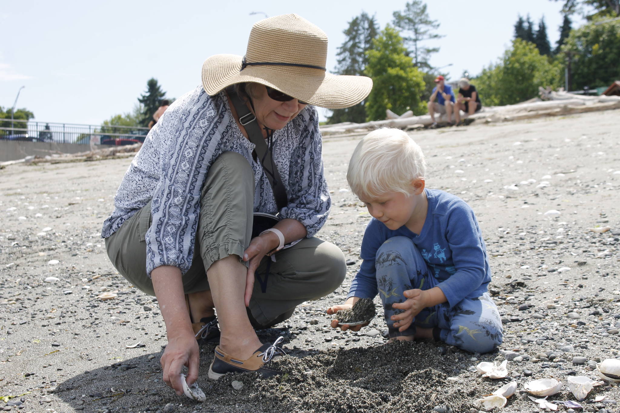 Sue Johnson and her 3-year-old grandson, Mikkel Brown, search for seashells at Clinton Beach Park on Wednesday. (Photo by Kira Erickson/South Whidbey Record)