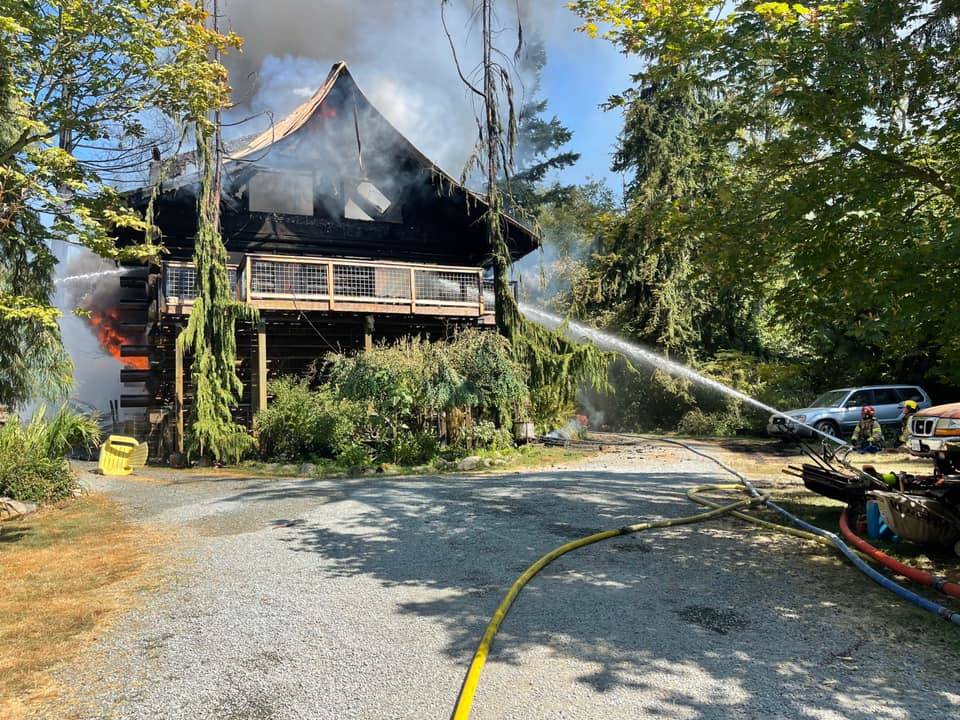Firefighters respond to a structure fire on Woodbine Road Monday. (Photo courtesy of South Whidbey Fire/EMS)