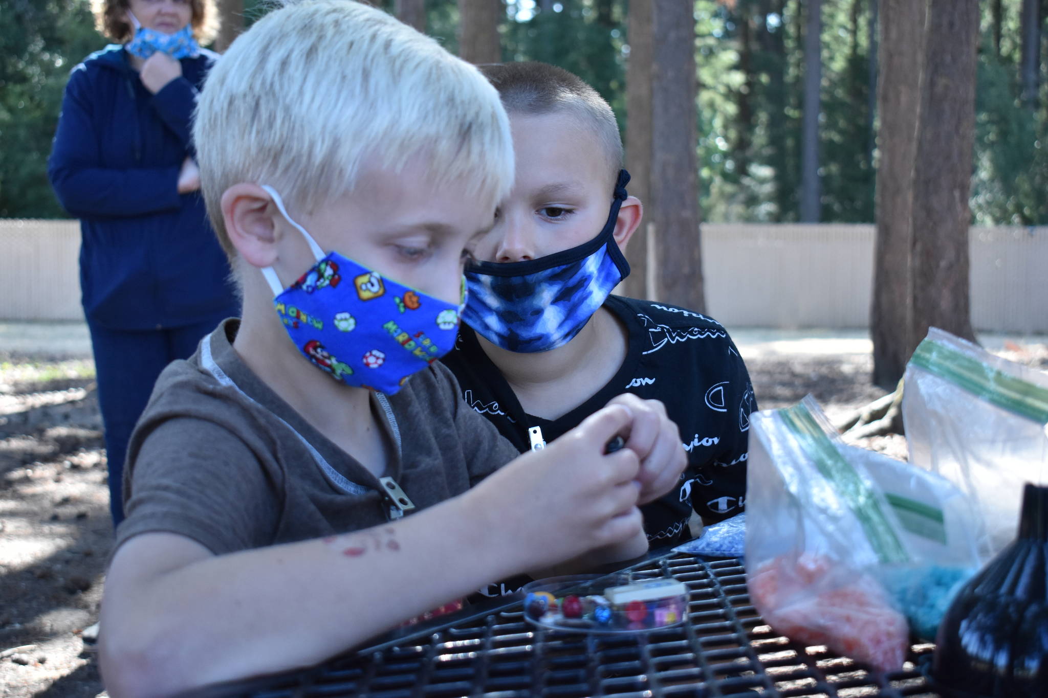 Photo by Emily Gilbert/Whidbey News-Times
Toby Grubbs and Dallas Owen work on eye spy bottles during a summer program at Olympic View Elementary in Oak Harbor.