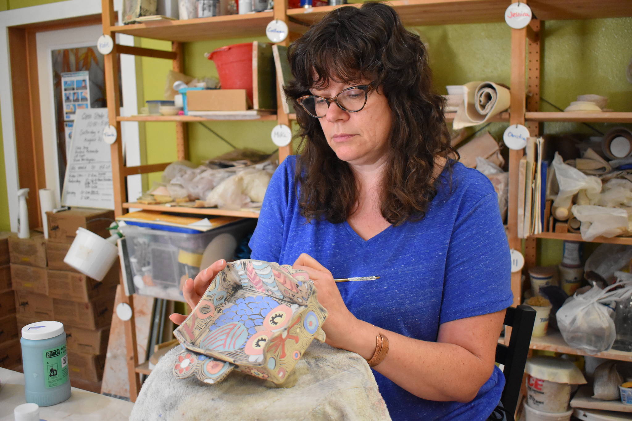 Tricia Vanslageren glazes some of her artwork at Whidbey Clay Center in Freeland. She will be showing her pieces there along with three other artists during the Whidbey Working Artists Summer Open Studio Tour this weekend. (Photo by Emily Gilbert/Whidbey News-Times)