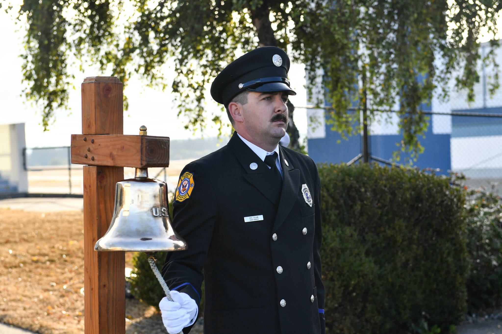 Navy photo by Mass Communications Specialist Second Class (MC2) Aranza Valdez
Eric Dolan, a driver/operator with Navy Region Northwest Fire and Emergency Services, rings a bell Friday, Sept. 10, during NAS Whidbey Island’s ceremony to remember the 9/11 terrorist attacks 20 years ago.