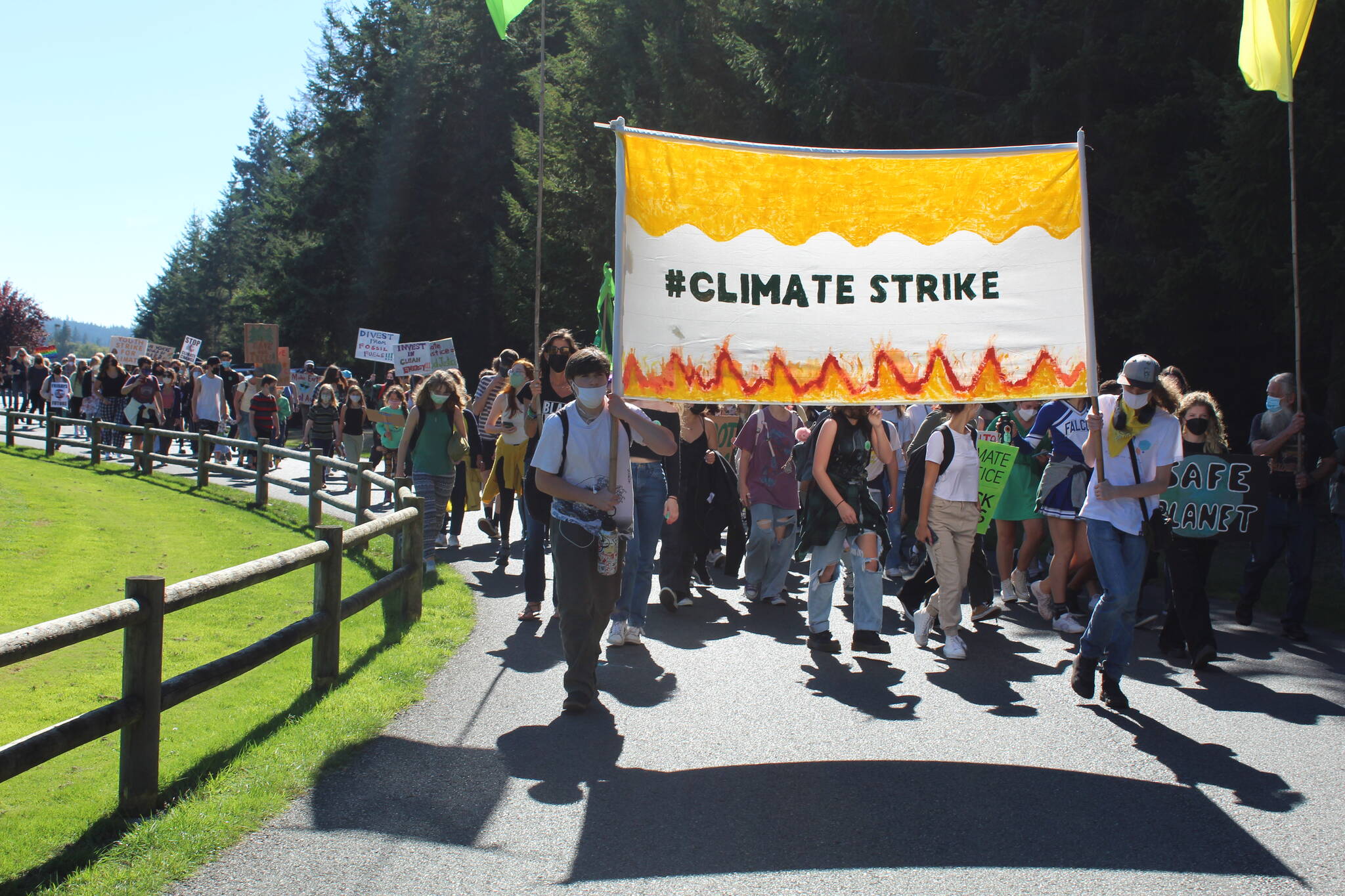 Students and community members march through Castle Park to demand climate justice. (Photo by Karina Andrew/Whidbey News-Times)