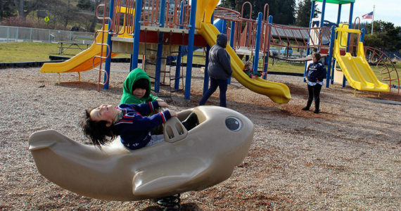 Children play at the Freeland Park in 2019. The aging playground equipment is scheduled to be replaced next year.