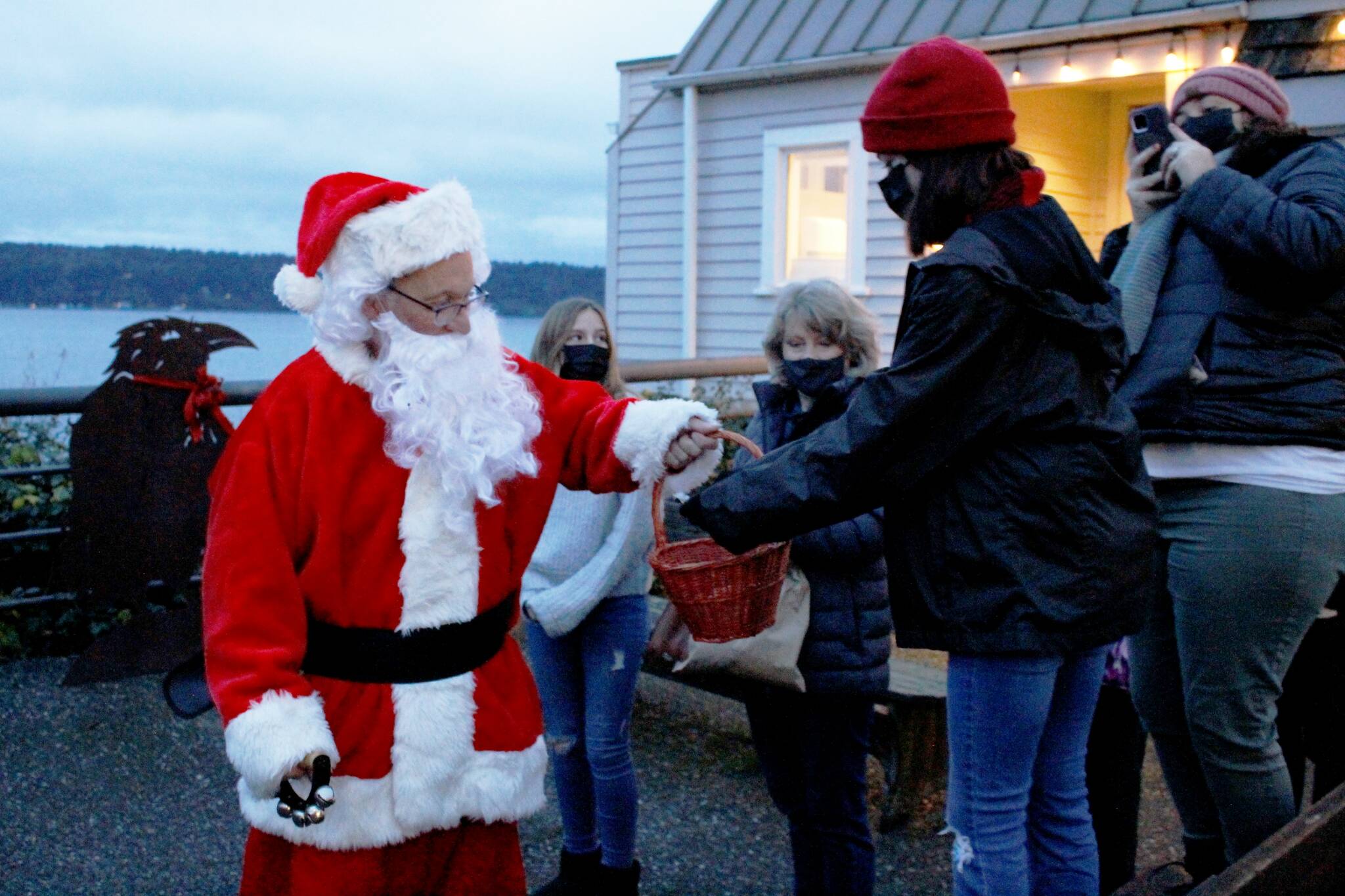 Photo by Kira Erickson/South Whidbey Record
Santa Claus, played this year by Mark Stewart Cassidy, handed out gobs of candy canes to a crowd of children Saturday evening in Langley during the citys annual Tree Lighting Ceremony. The big jolly red man traveled to three different Christmas trees in the Village by the Seas downtown corridor.