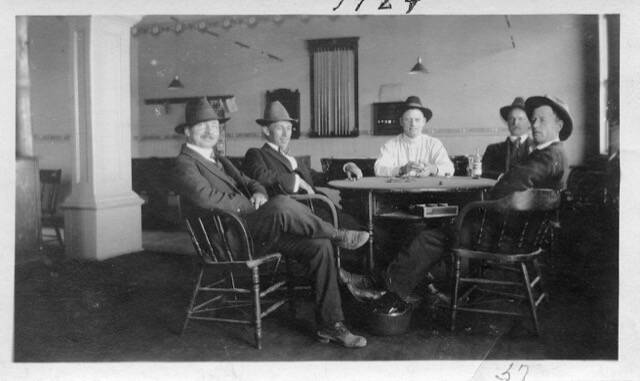 C.C. Cushen, at far left, presides over what looks like a game of cards with his buddies in the billiard room of his Central Hotel in 1924.