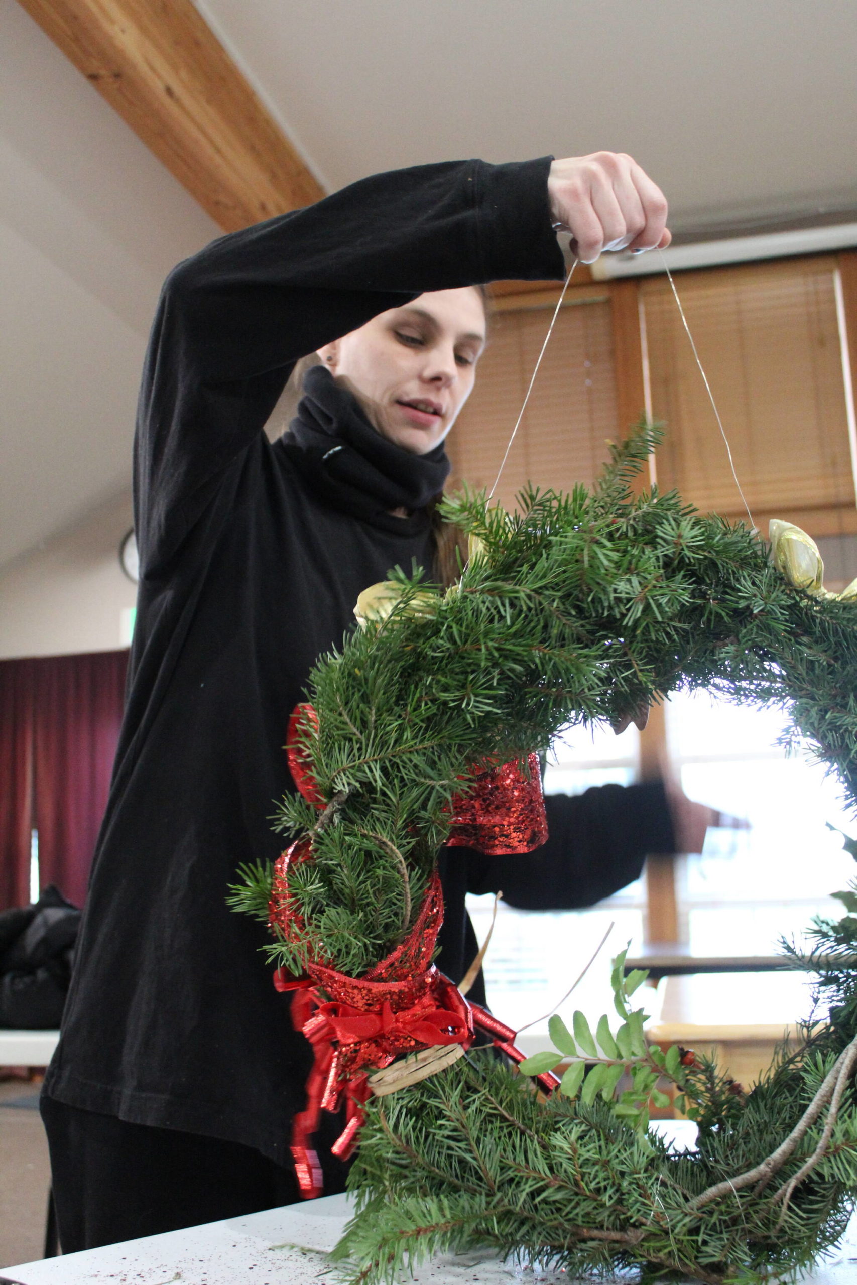 Pacific Rim Institute intern Dawn Meredith puts together a holiday wreath made of native plants.