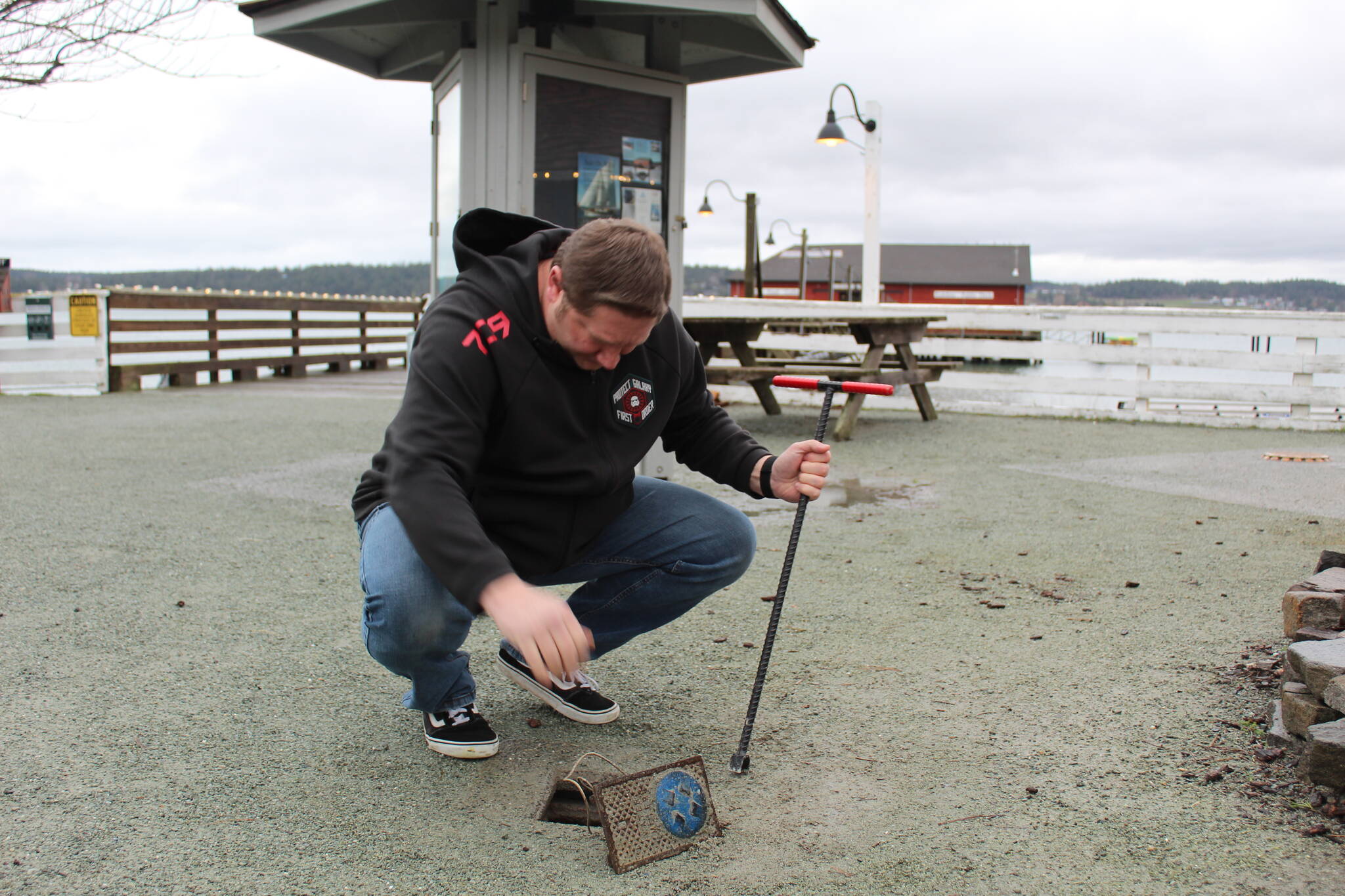 Photo by Karina Andrew/Whidbey News-Times
Chris Michalopoulos turns off the water to the wharf.