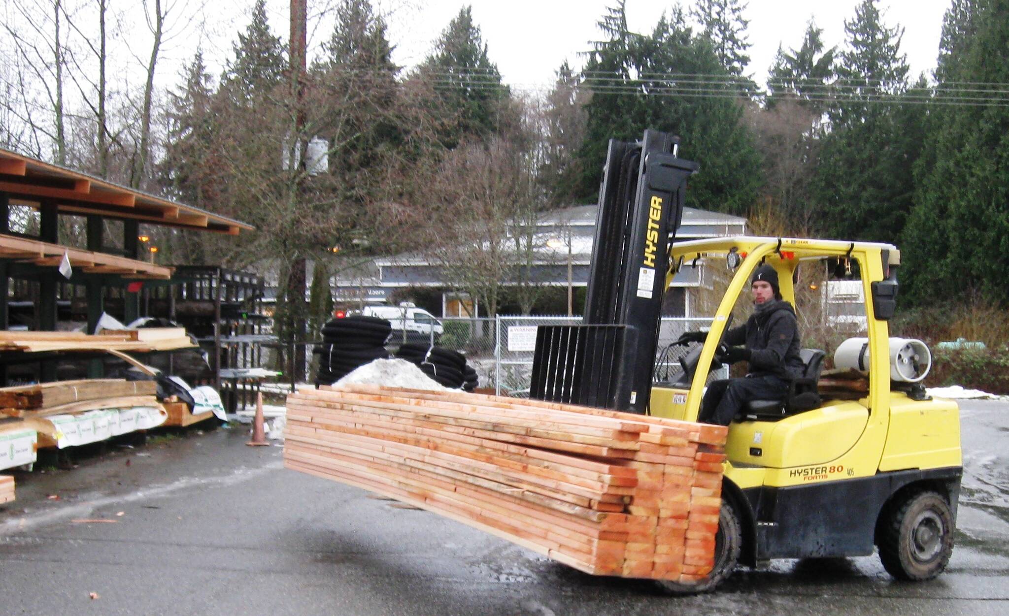 Yard attendant Brady Mullins drives a forklift to load 2x6 boards at Frontier Building Supply in Freeland. With high demand and diminished supply, lumber costs nearly twice as much now as two months ago. (Photo by Dave Felice)