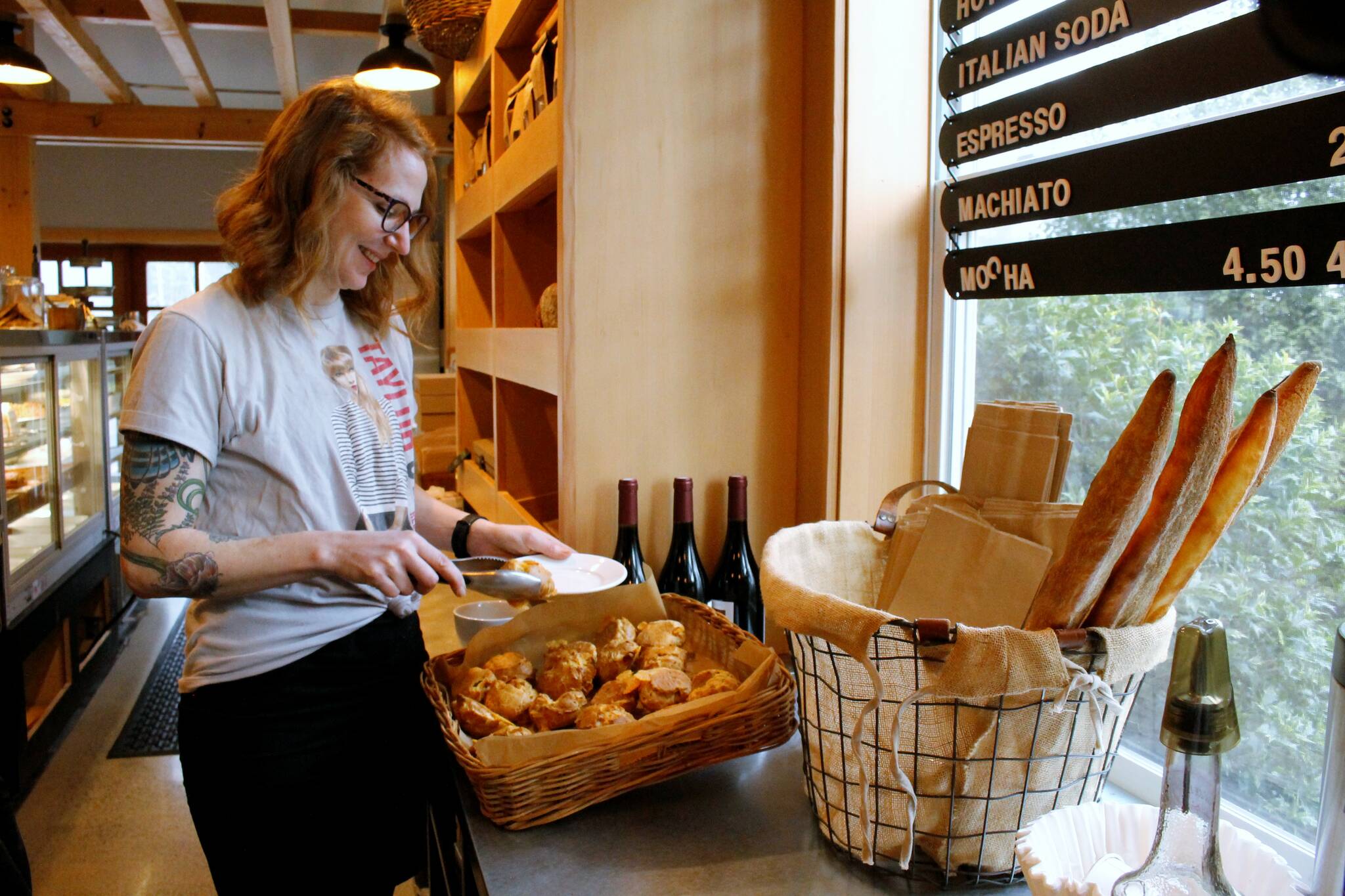 Photos by Kira Erickson/South Whidbey Record
Hannah McCabe, the manager of Seabiscuit Bakery, grabs a gougère to serve.