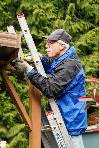 Ted Ravetz repairs a gutter during a previous work day for South Whidbey Hearts & Hammers.
