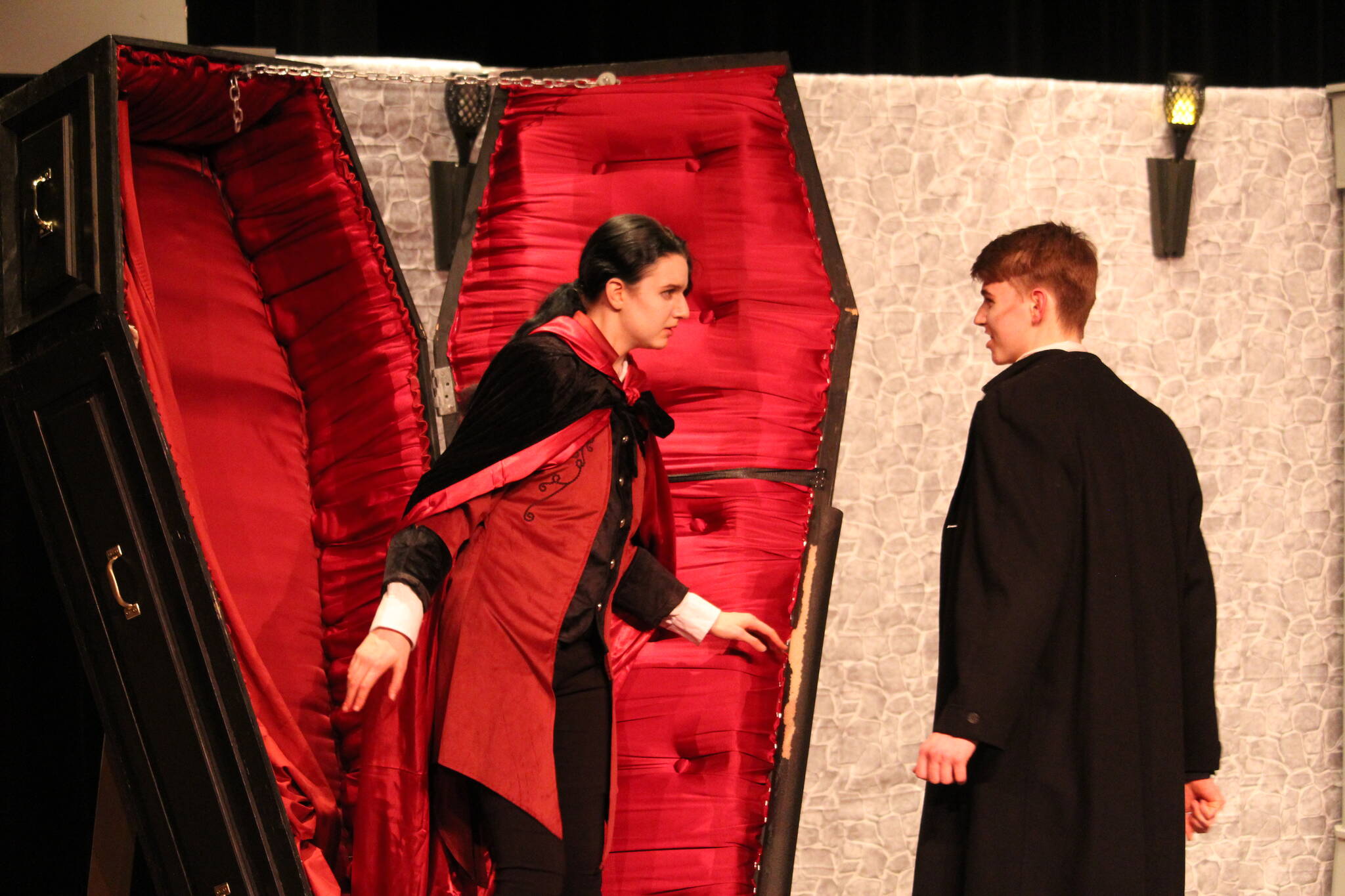 Count Dracula, played by Zoe Eisenbrey, emerges from his coffin to confront Jonathan Harker, played by Spencer Grubbs.