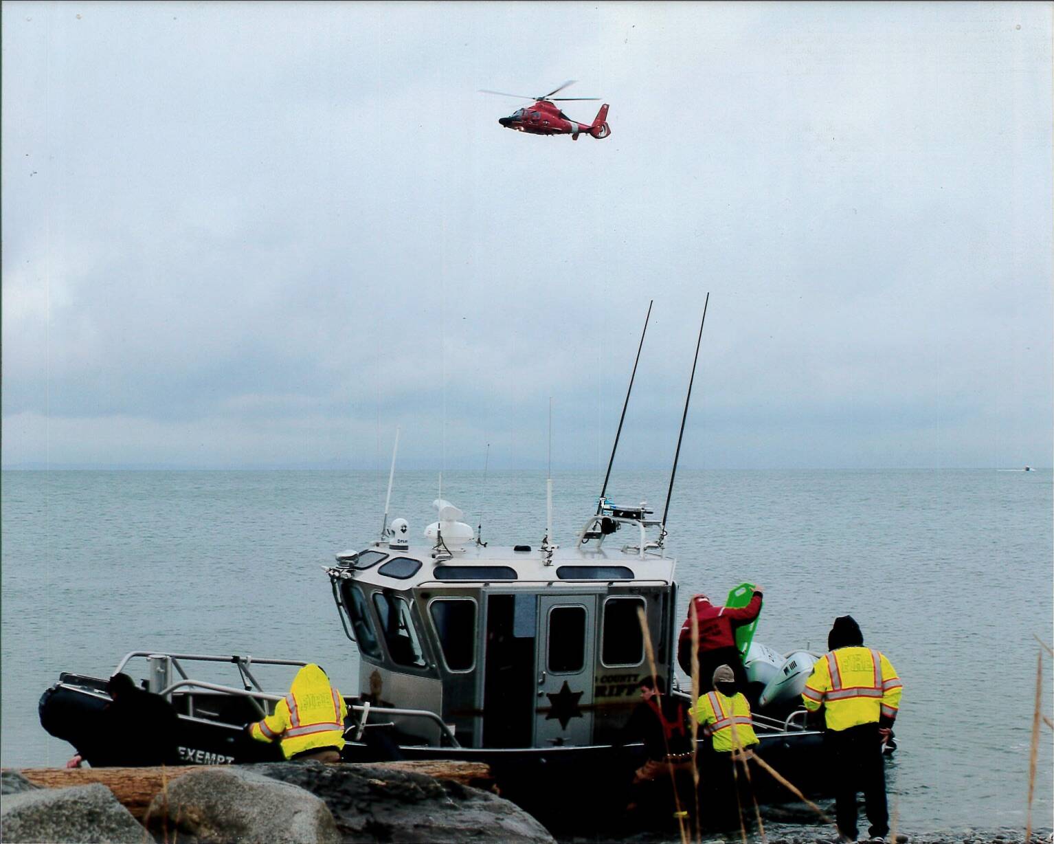 Photo provided
An Island County Sheriff’s Office boat and a Coast Guard helicopter set out to retrieve a body near Whidbey Island.