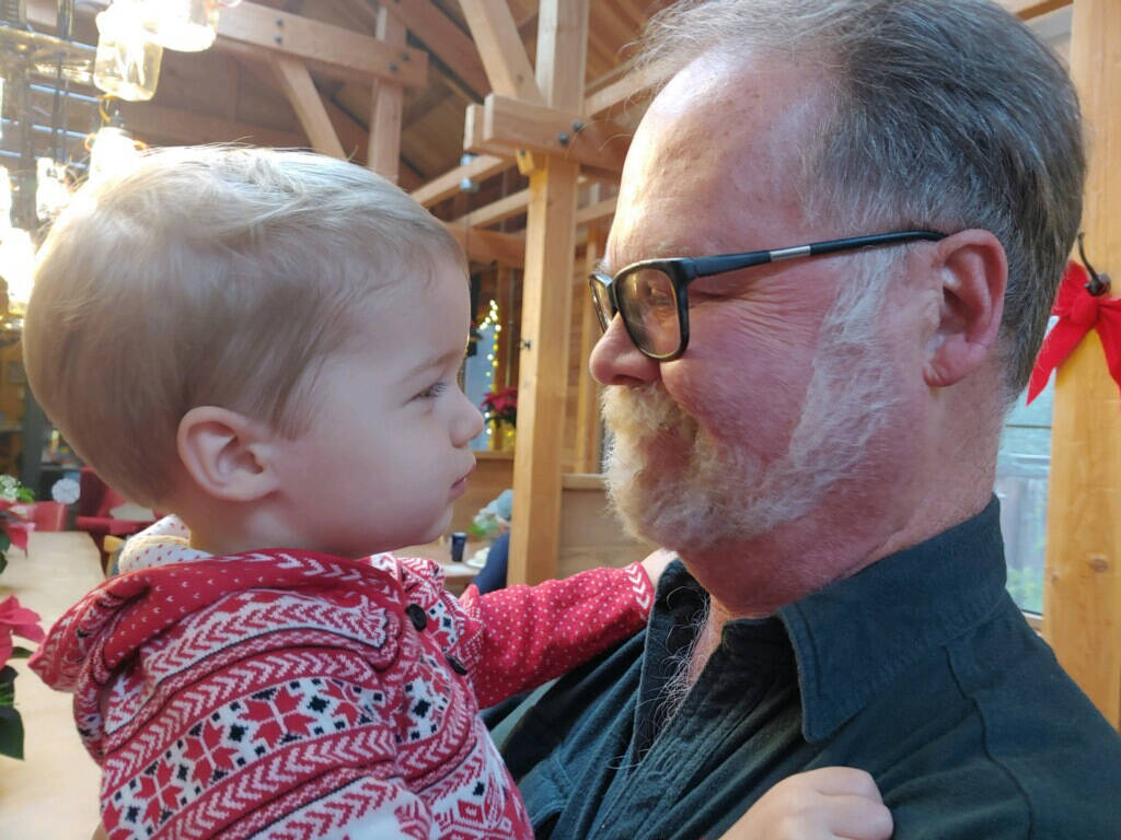 Bob Craven and grandchild Marin. Bob carried on the family business, Craven Insurance, with offices in Clinton and Lake Stevens.